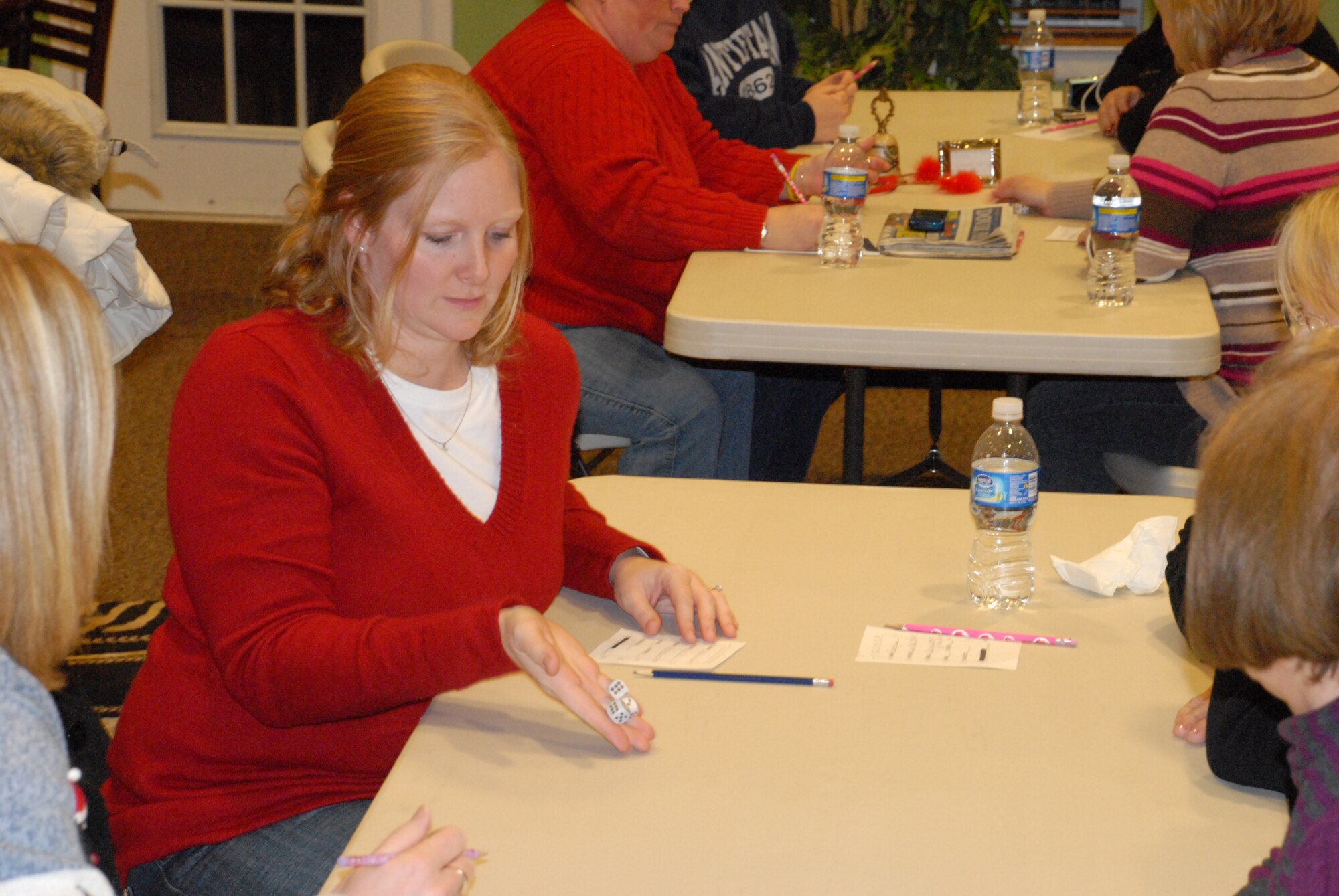 Christin Michaud, wife of Master Sgt. Russell Michaud, 436th Security Forces Squadron, plays a game of Bunko Bingo during the Spouses Social at the Dover Community Center Dec. 11.  Bunko Bingo is one of several Year of the Air Force Family events the Airman and Family Readiness Center is hosting.  (U.S. Air Force photo/Staff Sgt. Chad Padgett)