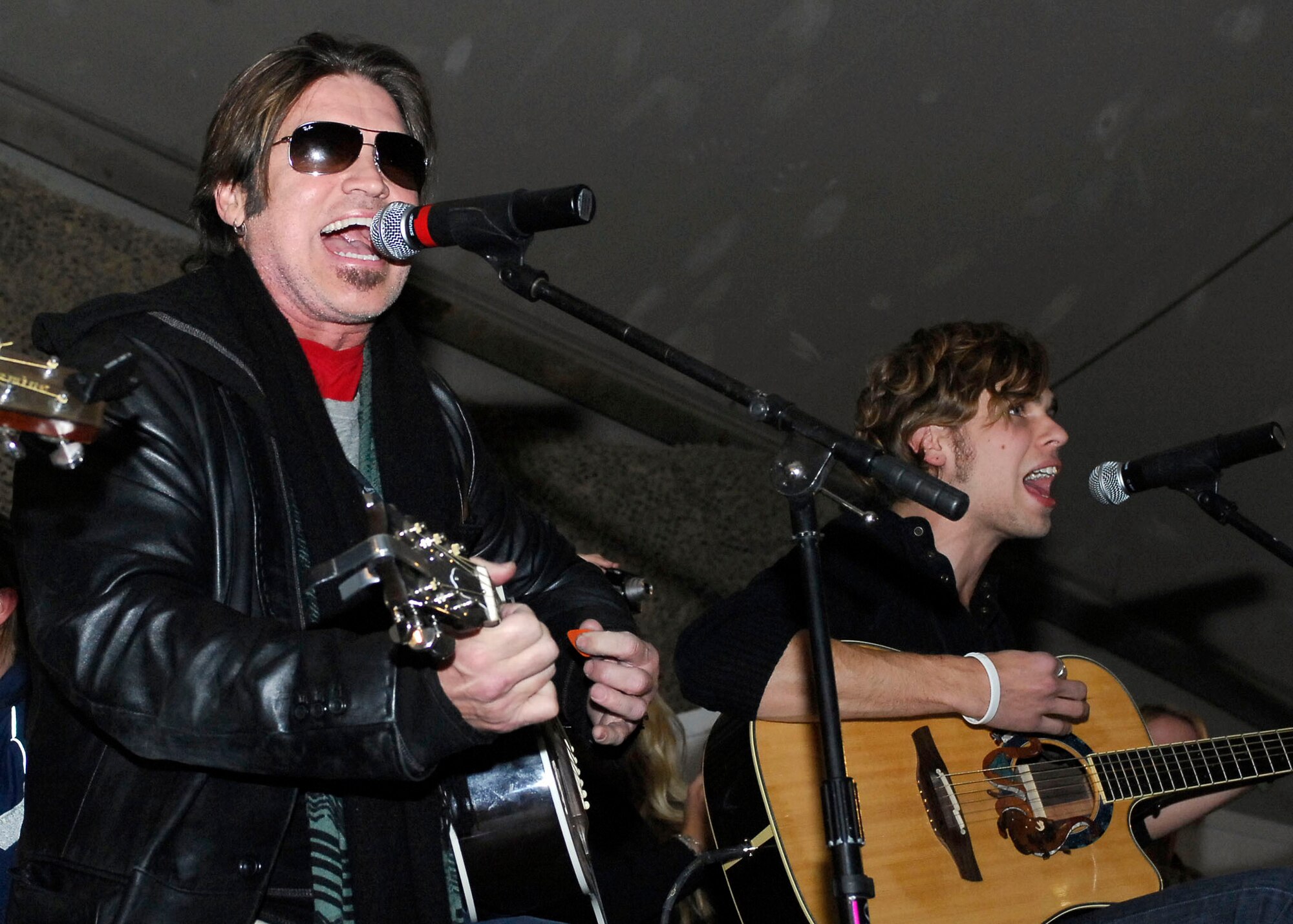 BAGRAM AIRFIELD, Afghanistan -- Billy Ray Cyrus, singer/ actor, entertains the Airmen, Soldiers, Sailors and Marines of Bagram Airfield during a United Service Organization tour Dec. 15, 2009.  Mr. Cyrus, Dave Attell, Anna Kournikova, and Nick Bollettieri attended the USO tour to boost the morale of the servicemen and women.  Mrs. Kournikova, tennis pro, originally from Russia, now hails from Miami, Fla.  Mr. Attell, a comedian, is originally from Queens, N.Y.  Mr. Cyrus hails from Flatwoods, Ky.  Mr. Bollettieri, tennis coach/ motivational speaker, hails from Pelham, N.Y.  (U.S. Air Force photo/Senior Airman Felicia Juenke)