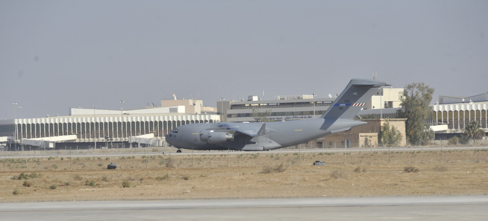 A C-17 from the multinational Heavy Airlift Wing based at Papa Air Base, Hungary  taxis past the terminal at Baghdad International Airport. The airlift into Iraq was a first by the wing comprised of 12 member nations and facilitated the deployment for members of the NATO Training Mission-Iraq. The wing operates three C-17s and includes NATO member nations Bulgaria, Estonia, Hungary, Lithuania, the Netherlands, Norway, Poland, Romania, Slovenia and the U.S., as well as Partnership for Peace nations Finland and Sweden.
