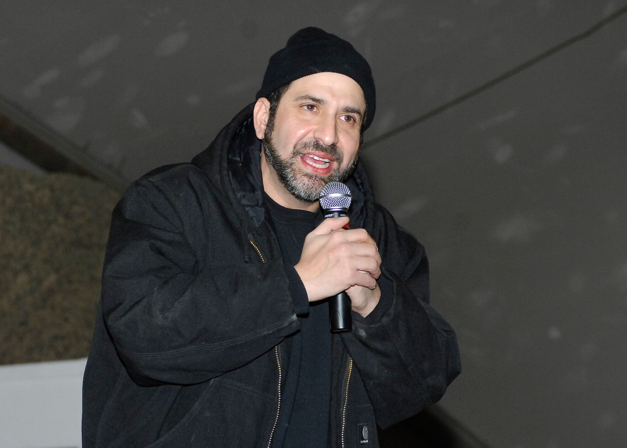 BAGRAM AIRFIELD, Afghanistan -- Dave Attell, a comedian, entertains the Airmen, Soldiers, Sailors and Marines of Bagram Airfield during a United Service Organization tour Dec. 15, 2009.  Mr. Attell, Billy Ray Cyrus, Anna Kournikova and Nick Bollettieri attended the USO tour to boost the morale of the servicemembers.  Mr. Attell is originally from Queens, N.Y.  Mr. Cyrus, singer/ actor, hails from Flatwoods, Ky.  Mrs. Kournikova, tennis pro, originally from Russia, now hails from Miami, Fla.  Mr. Bollettieri, tennis coach/ motivational speaker, hails from Pelham, N.Y.   (U.S. Air Force photo/Senior Airman Felicia Juenke)