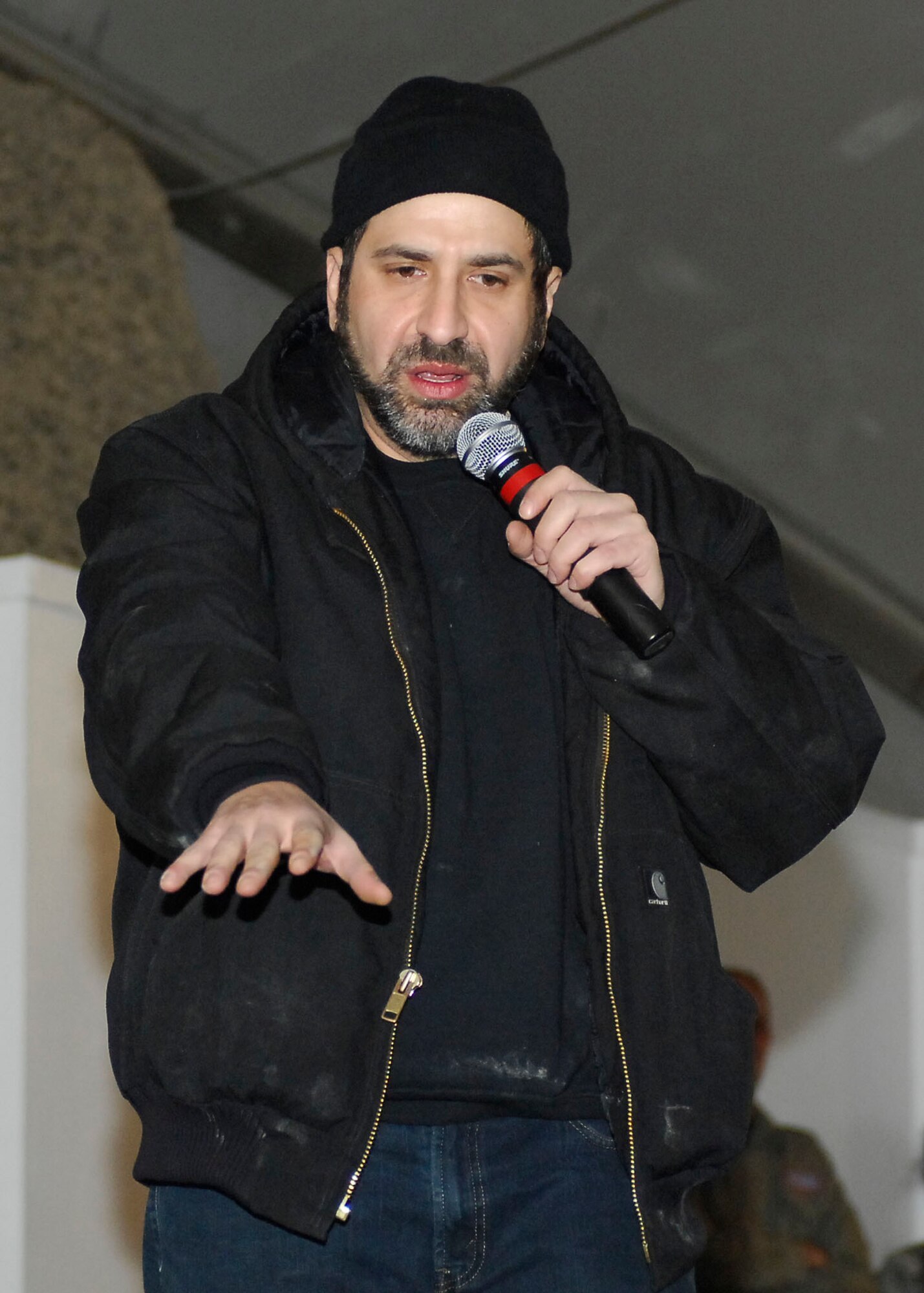 BAGRAM AIRFIELD, Afghanistan -- Dave Attell, a comedian, entertains the Airmen, Soldiers, Sailors and Marines of Bagram Airfield during a United Service Organization tour Dec. 15, 2009.  Mr. Attell, Billy Ray Cyrus, Anna Kournikova and Nick Bollettieri attended the USO tour to boost the morale of the servicemembers.  Mr. Attell is originally from Queens, N.Y.  Mr. Cyrus, singer/ actor, hails from Flatwoods, Ky.  Mrs. Kournikova, tennis pro, originally from Russia, now hails from Miami, Fla.  Mr. Bollettieri, tennis coach/ motivational speaker, hails from Pelham, N.Y.  (U.S. Air Force photo/Senior Airman Felicia Juenke)