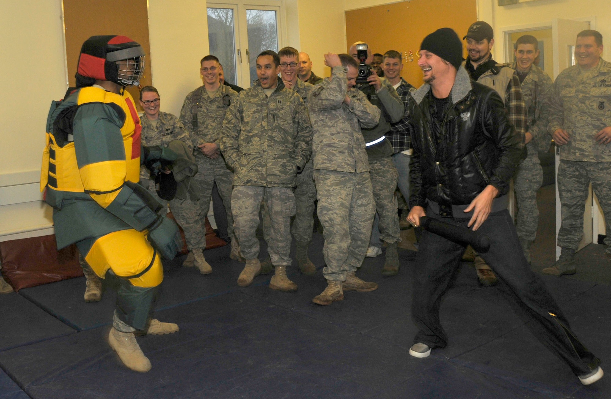 Kid Rock prepares to swing a baton at Airman 1st Class Melvin Walker, 48th Security Forces Squadron member, at RAF Feltwell, England, Dec. 10. Kid Rock toured the facility called Defense University and participated in a few training exercises. Kid Rock was joined by comedian Carlos Mencia and singer Jessie James as they toured bases in Europe and Southwest Asia to show their appreciation and support for the military.  (U. S. Air Force photo/Airman 1st Class Eboni Knox) 