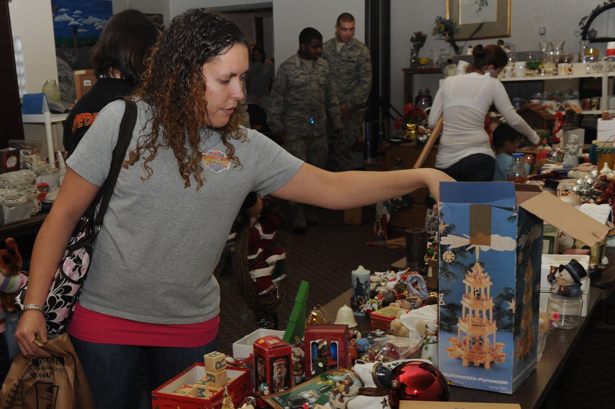 SHAW AIR FORCE BASE, S.C. -- Jennifer, wife of Senior Airman James Caruana, 55th Fighter Squadron crew chief, browses through the Christmas decorations at the Airman's Attic during the "Christmas at the Attic" event Dec. 15. Christmas at the Attic has been an annual event for the Airman's Attic for the past three years. (U.S. Air Force photo/Senior Airman David Minor)