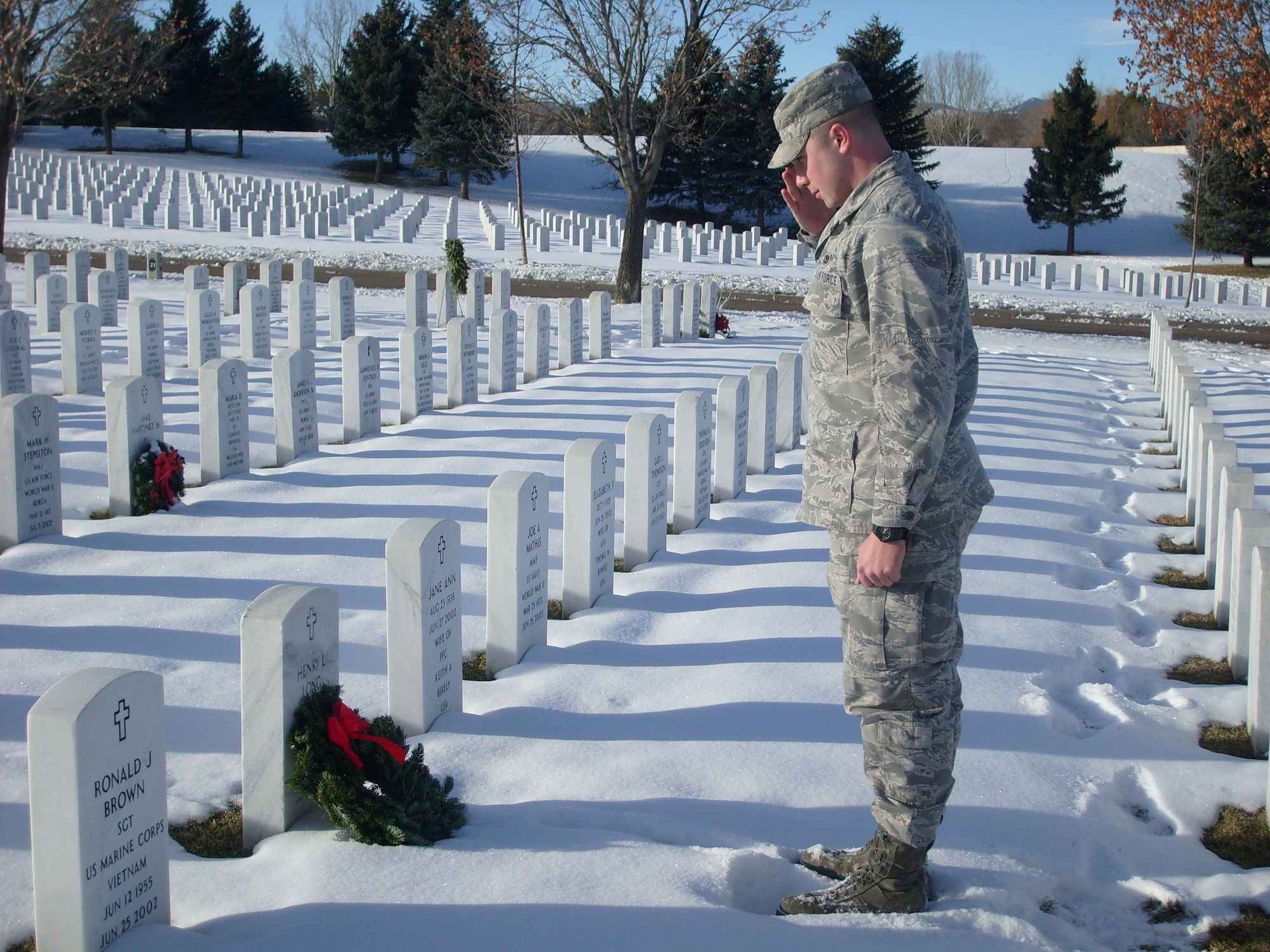 1st Lt. Brandon Goebel places a wreath on the grave of Navy Seaman Apprentice Henry L. Long. Seaman Long's family requested Lieutenant Goebel visit the grave during Wreaths Across America and place a wreath. (Photo courtesy of U.S. Air Force Master Sgt. Timothy O'Connor)