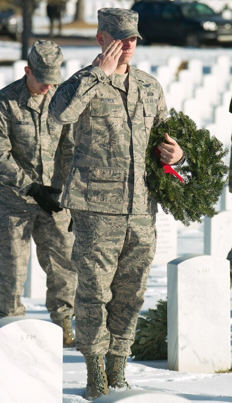 Tech. Sgt. David Plemen, 566th Intelligence Squadron, salutes after laying a wreath during Wreaths Across America Dec. 12. (U.S. Air Force photo by Master Sgt. Steven Clark)