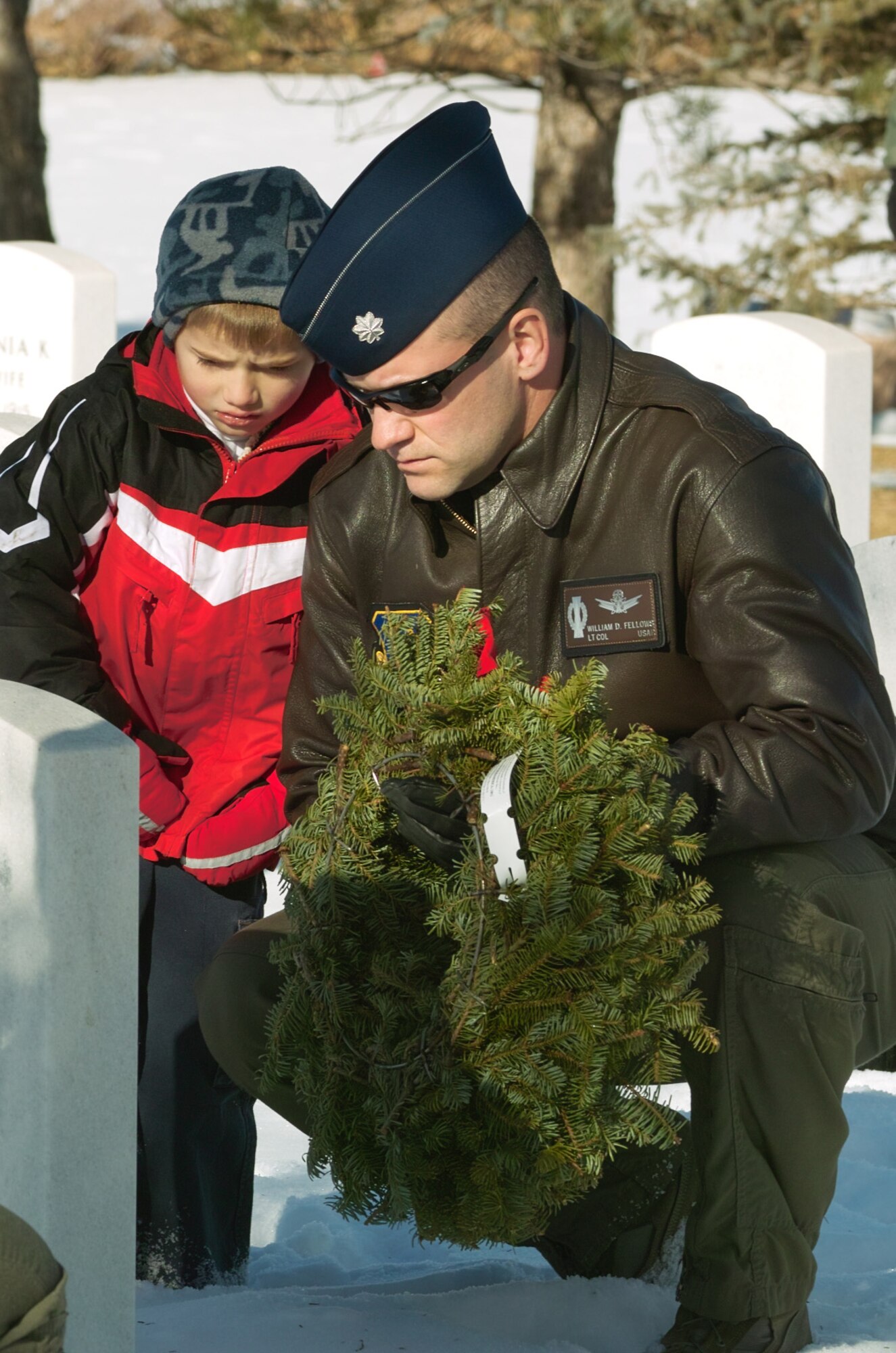 Lt. Col. William Fellows from Schriever Air Force Base, Colo., lays a wreath during Wreaths Across America Dec. 12 at Fort Logan National Cemetary in Littleton, Colo. The Wreaths Across America program is run by the Civil Air Patrol. CAP members and volunteers from local military installations lay wreaths on graves in veterans' cemetaries nationwide. (U.S. Air Force photo by Master Sgt. Steven Clark)