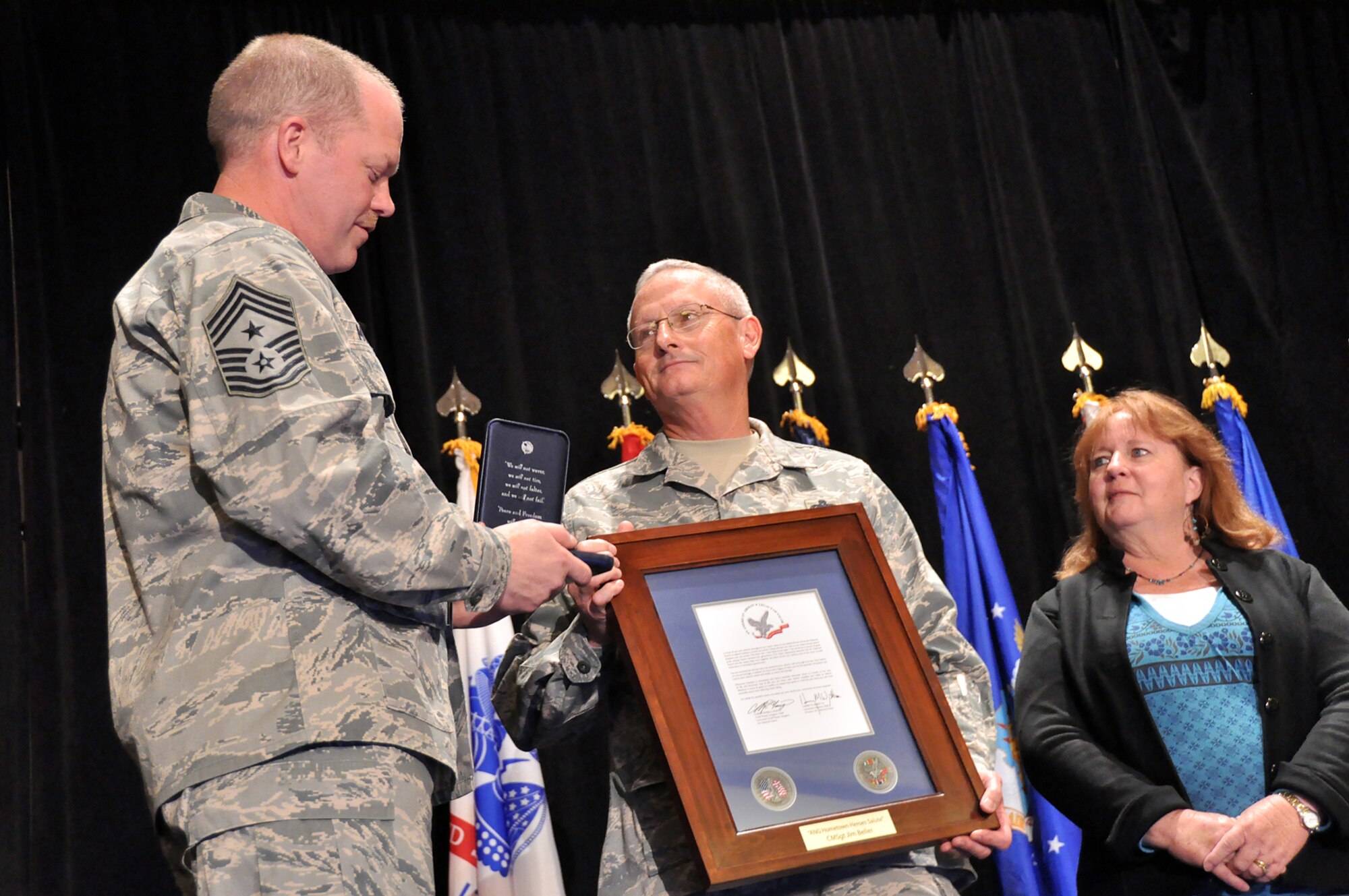 Chief Master Sgt. Christopher Muncy, command chief of the Air National Guard, awards a Hometown Heroes Salute Campaign award to Chief Master Sgt. James Beller, command chief of the Oklahoma Air Guard, at the National Guard Bureau's Joint Senior Leadership Conference outside Washington Nov. 20, 2009.
The award campaign honored thousands of Citizen-Airmen, families and civilians this year for their service and support and will continue into 2010.