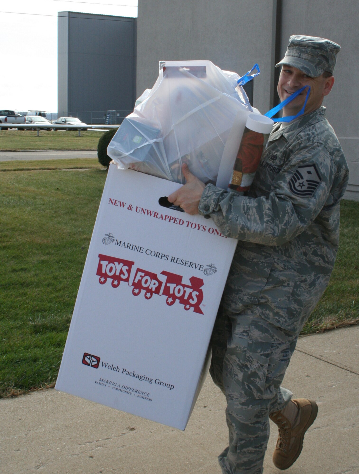 WRIGHT-PATTERSON AIR FORCE BASE, Ohio – Master Sgt. John Koehl, 445th Security Forces Squadron first sergeant, picks up a box of toys donated to the Toys for Tots campaign at the 445th Airlift Wing headquarters building Dec. 14.  More than seven boxes of toys were collected throughout the wing and distributed to the base drop off point. The mission of the U. S. Marine Corps Reserve Toys for Tots Program is to collect new, unwrapped toys October through December each year, and distribute those toys as Christmas gifts to needy children in the community in which the campaign is conducted. (U.S. Air Force photo/Stacy Vaughn) 
