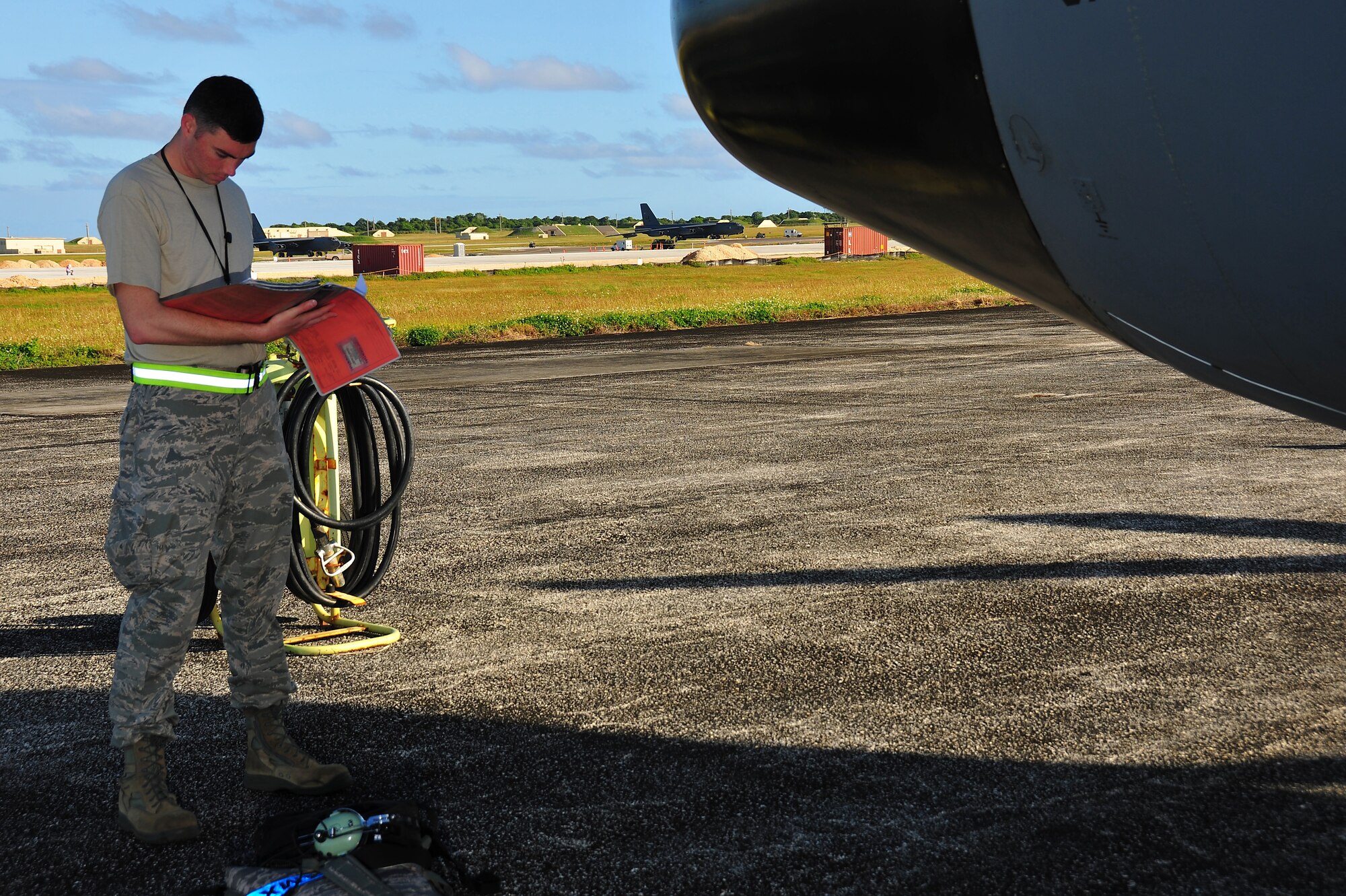 ANDERSEN AIR FORCE BASE, Guam -- Tech. Sgt. William Cornett, 374th Maintenance Group quality assurance inspector, reviews forms before a C-130 Hercules departs here on the first day of Operation Christmas Drop Dec. 16. Operation Christmas Drop, the longest running humanitarian airlift mission in the world, delivers supplies to remote islands of the Commonwealth of the Northern Marianas Islands of Yap, Palau, Chuuk and Pohnpei. (U.S. Air Force photo/Tech. Sgt. Kimberly Spinner)