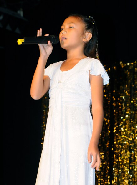 Juzel Mae Evangelio, daughter of Staff Sgt. Jonathan Weppel, 728th Air Mobility Squadron, performs “Concrete Angel” by Martina McBride Thursday, Dec. 10, 2009, during the Family and Teen Talent Show at Incirlik’s Community Center. The participants were judged on their performance and showmanship and a winner from each category was selected. The winners then had a tape of their performance sent to the Air Force level for judging. (U.S. Air Force photo/Airman 1st Class Amber Ashcraft)