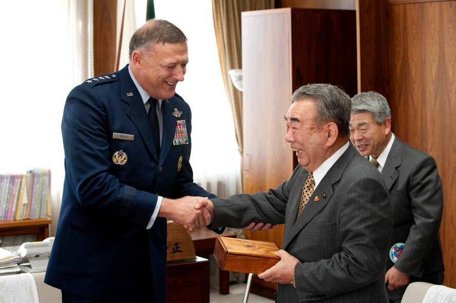 MISAWA CITY, Japan -- Gen. Gary North, Pacific Air Forces commander, shakes hands with Misawa City Mayor Kazumasa Taneichi Dec. 16 during a gift exchange in the Misawa City Mayor's office. The gift exchange is a Japanese custom, which demonstrates mutual respect. (Air Force photo/Staff Sgt. Samuel Morse) 
