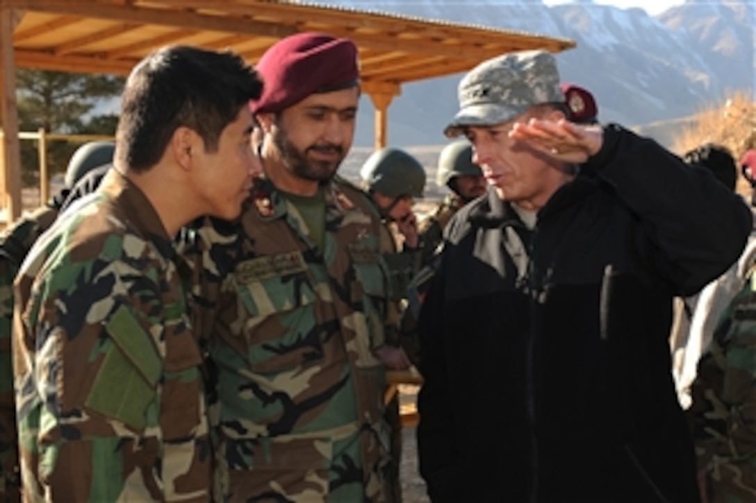 U.S. Army Gen. David Petraeus, right, commander of U.S. Central Command, talks to Afghan National Army Col. Dadan Lawang through his translator at Camp Morehead in Kabul, Dec. 16, 2009. 