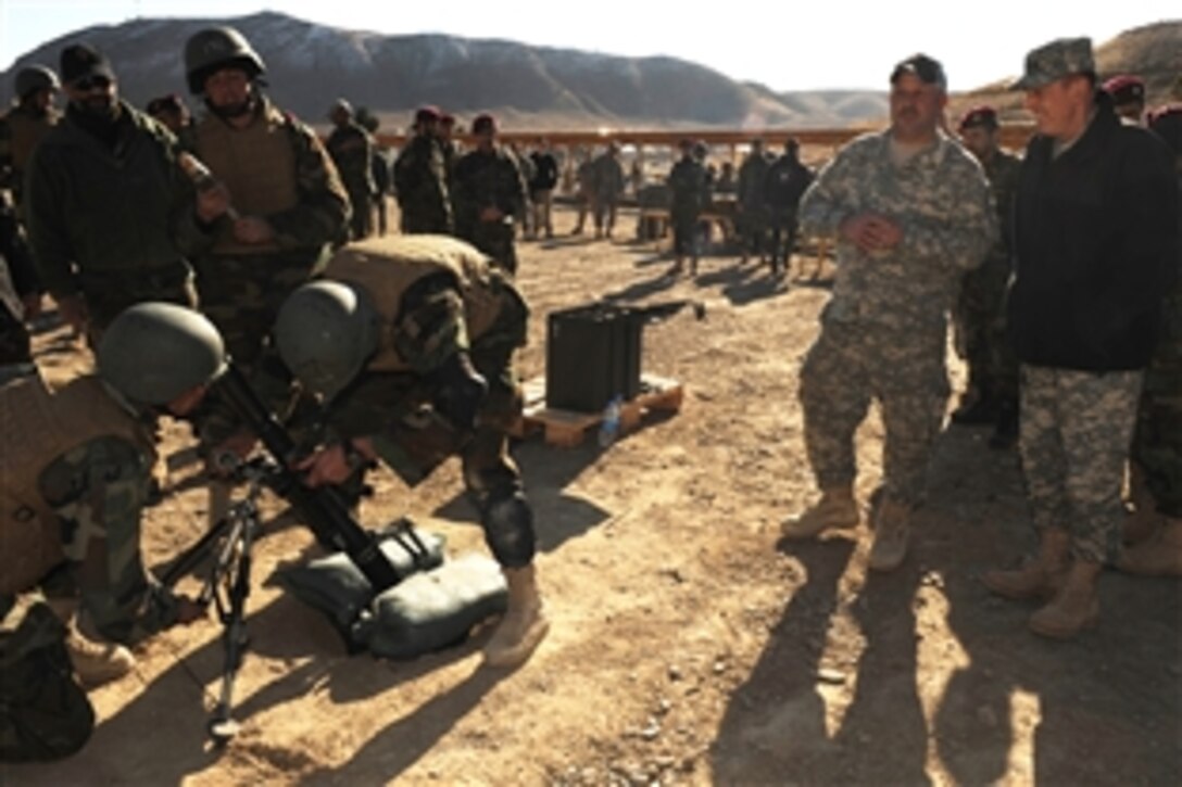 U.S. Army Gen. David Petraeus, right, commander of U.S. Central Command, watches members of the Afghan National Army prepare to fire mortars at targets during a demonstration at Camp Moreheadl in Kabul, Dec. 16, 2009. 