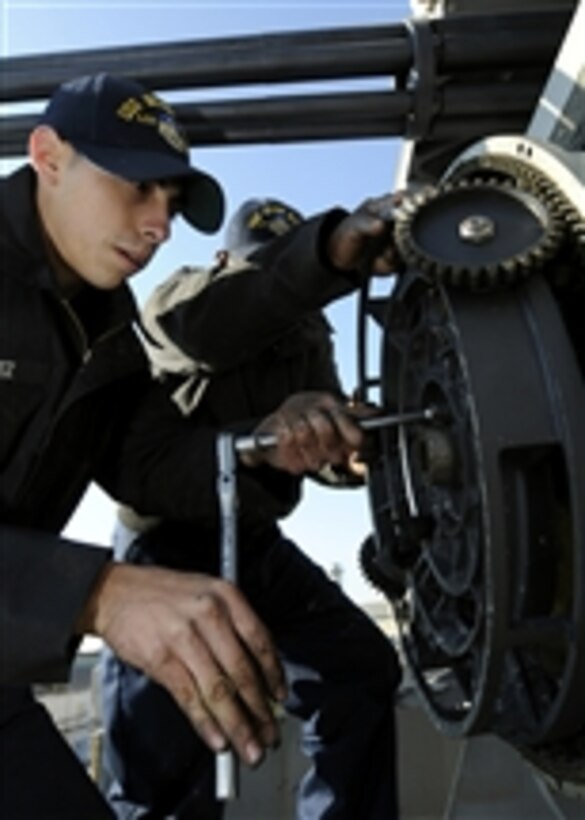 U.S. Navy Petty Officer 3rd Class Ivan Galvez works on a close-in weapons system aboard the U.S. 7th Fleet command ship USS Blue Ridge (LCC 19) in Yokosuka, Japan, on Dec. 8, 2009.  The Blue Ridge sailors are performing preventative maintenance on the close-in weapons system while the ship is in port.  