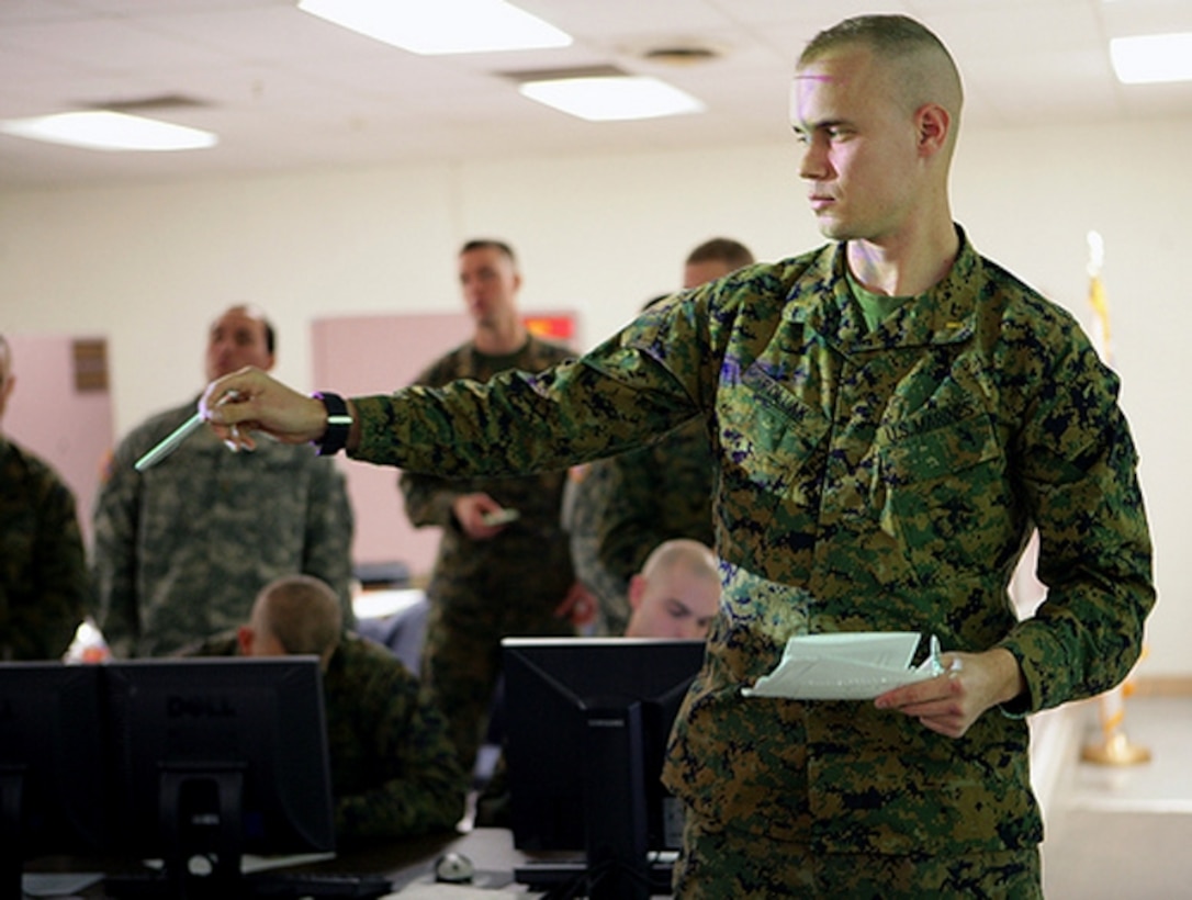 Second Lt. Charles Pollak from 5th Battalion, 14th Marine Regiment briefs his team as part of battle simulations training here Dec. 16, 2009.  Pollak is a Reserve Marine officer currently going through the U.S. Army's field artillery school.
