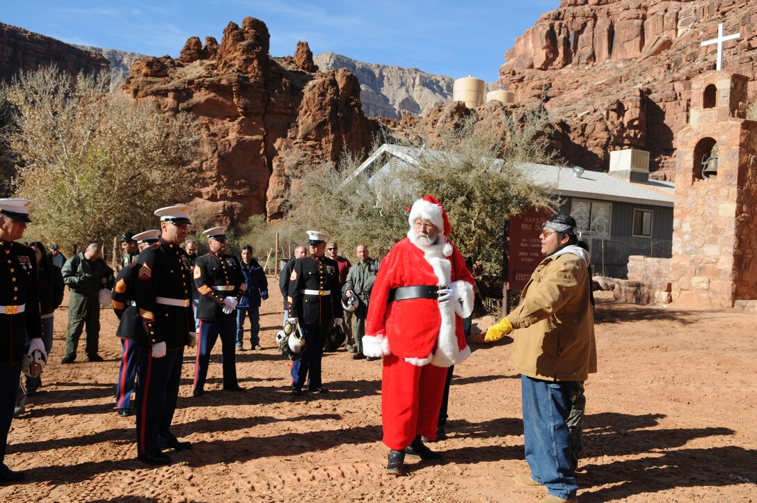 Matthew Putesoy Sr., vice chairman of the Havasupai tribal council, welcomes Santa Claus and Marine reservists from the Phoenix-based Environmental Services Detachment after they landed in Supai, Ariz., to deliver Christmas gifts to the tribe's more than 100 children as part of the Toys for Tots program on Dec. 16, 2009. Besides airlift, the only way to reach the village is via an eight-mile foot trail. For 14 years, Marine Medium Helicopter Squadron 764, a reserve unit based at Edwards Air Force Base north of Los Angeles, has flown donated toys to the village, nestled in a tributary canyon off the Grand Canyon's southern edge.