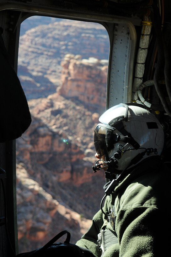 Sgt. Deborah L. Myatt, an aerial observer with Marine Medium Helicopter Squadron 764, looks out of a CH-46 Sea Knight as it flies through the Grand Canyon en route to the remote village of the Havasupai tribe in order to deliver Christmas gifts to children as part of the Toys for Tots program on Dec. 16, 2009. The reserve squadron, based at Edwards Air Force Base north of Los Angeles, has flown toys to the village's children for Christmas for the past 14 years. Myatt, 25, is a native of Lancaster, Calif.