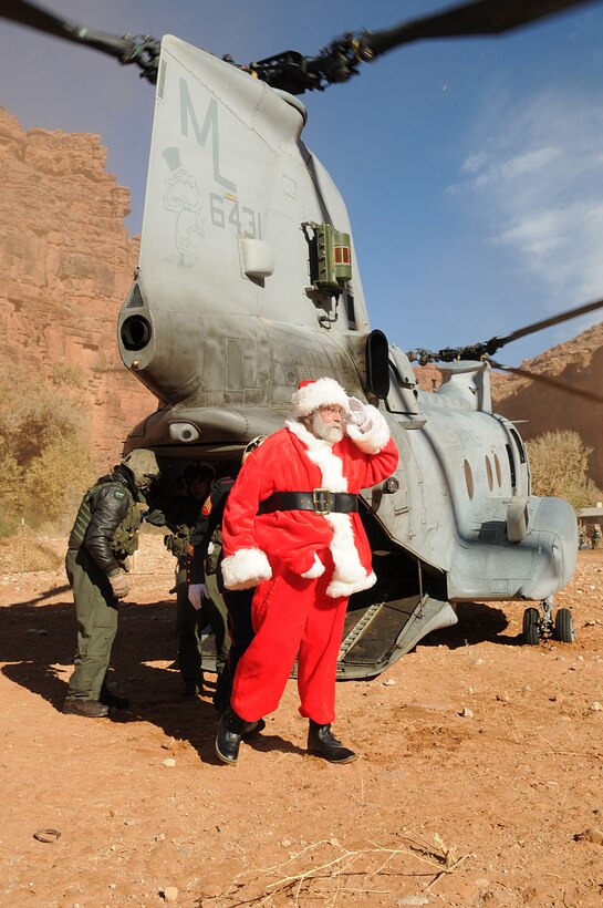 Santa Claus and other volunteers exit a CH-46E Sea Knight helicopter from Marine Medium Helicopter Squadron 764 Dec. 16, 2009, at the village of the Havasupai, a Native American tribe living on the floor of the Grand Canyon. During the event, Santa handed out several gifts from Toys for Tots to the children of the village. The previous day, three Sea Knights made several trips into the canyon, each time dropping off loads of toys and food to the tribe for the holidays. The reserve squadron, based at Edwards Air Force Base north of Los Angeles, has flown toys to the village's children for Christmas for the past 14 years.