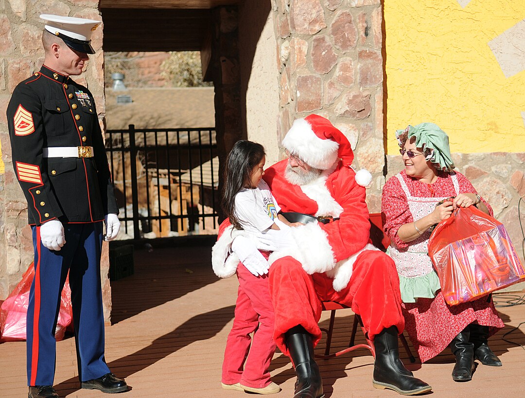 Santa Claus speaks to a Native American girl before giving her a Christmas gift at a Toys for Tots giveaway event at the Havasupai village on the floor of the Grand Canyon Dec. 16, 2009. The previous day, three CH-46E Sea Knight helicopters made several trips into the canyon, each time dropping off loads of toys and food to the tribe for the holidays. The reserve squadron, based at Edwards Air Force Base north of Los Angeles, has flown toys to the village's children for Christmas for the past 14 years.
