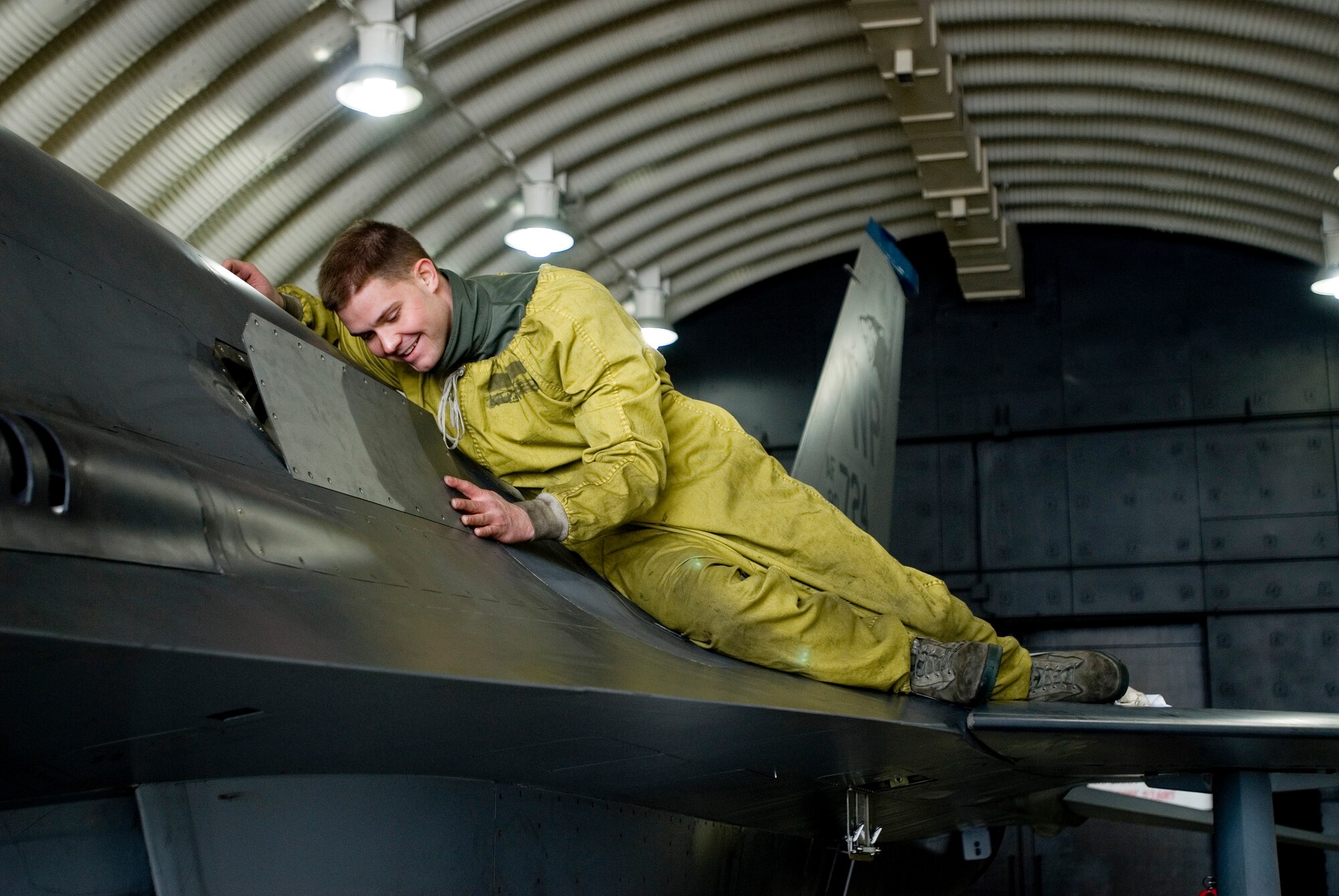 KUNSAN AIR BASE, Republic of Korea -- Staff Sgt. Nathaniel Olive, 35th Aircraft Maintenance Unit, reattaches a panel onto an F-16 Fighting Falcon Dec. 18. Sergeant Olive was buttoning up the F-16 after performing engine checks. (U.S. Air Force photo by/Senior Airman Jonathan Steffen)