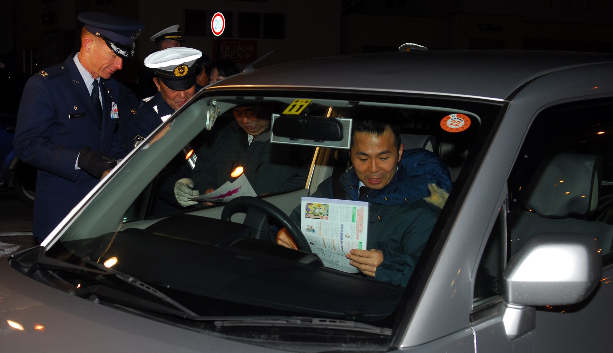 MISAWA CITY, Japan – Col. David Stilwell, 35th Fighter Wing commander, hands out traffic safety flyers Dec. 17, reminding motorists to drive safely during the winter. The flyers were written in Japanese and English, which helped get the message of winter driving safety out to everyone. (U.S. Air Force photo/Staff Sgt. Phillip Butterfield)  