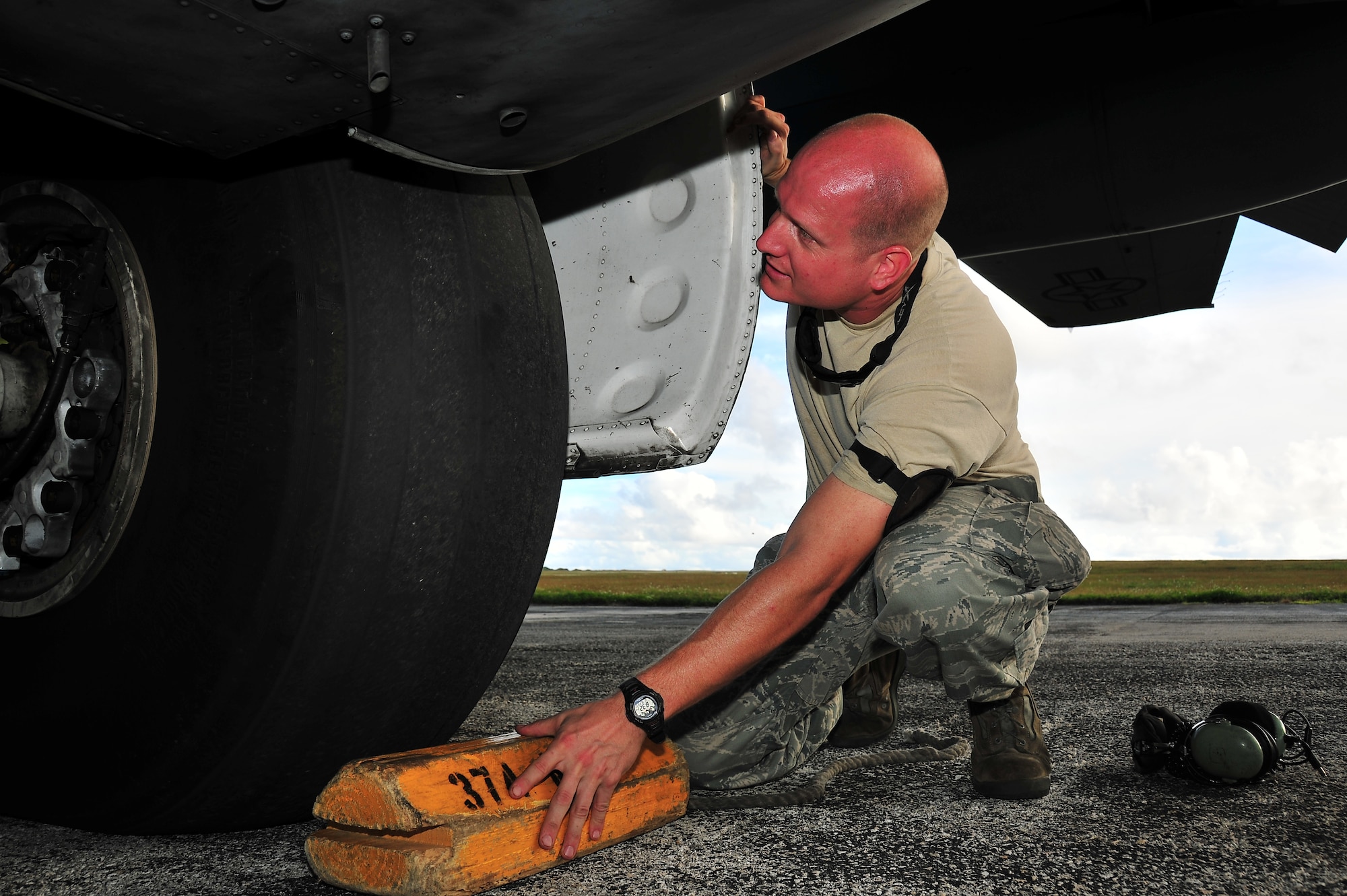ANDERSEN AIR FORCE BASE, Guam -- Tech. Sgt. Harper Douglas, 374th Maintenance Squadron crew chief, inspects a tire for wear on a C-130 Hercules in support of Operation Christmas Drop Dec. 18. Operation Christmas Drop, the longest running humanitarian airlift mission in the world, delivers supplies to remote islands of the Commonwealth of the Northern Marianas Islands of Yap, Palau, Chuuk and Pohnpei. (U.S. Air Force photo/Tech. Sgt. Kimberly Spinner)