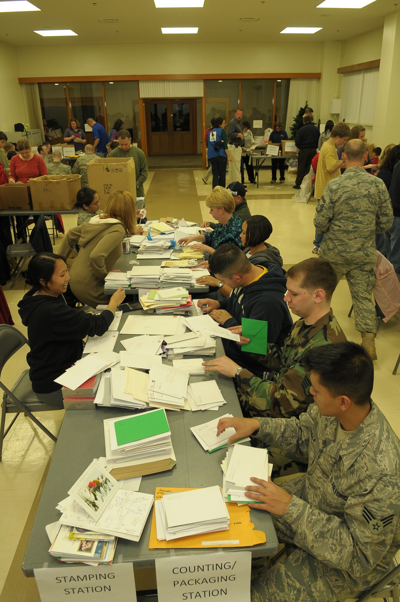 YOKOTA AIR BASE, Japan -- Volunteers sort and package more than 15,000 holiday cards Dec. 17 at the main chapel during the American Red Cross' "Holiday Mail for Heroes" campaign. (U.S. Air Force photo/Airman 1st Class Sean Martin)