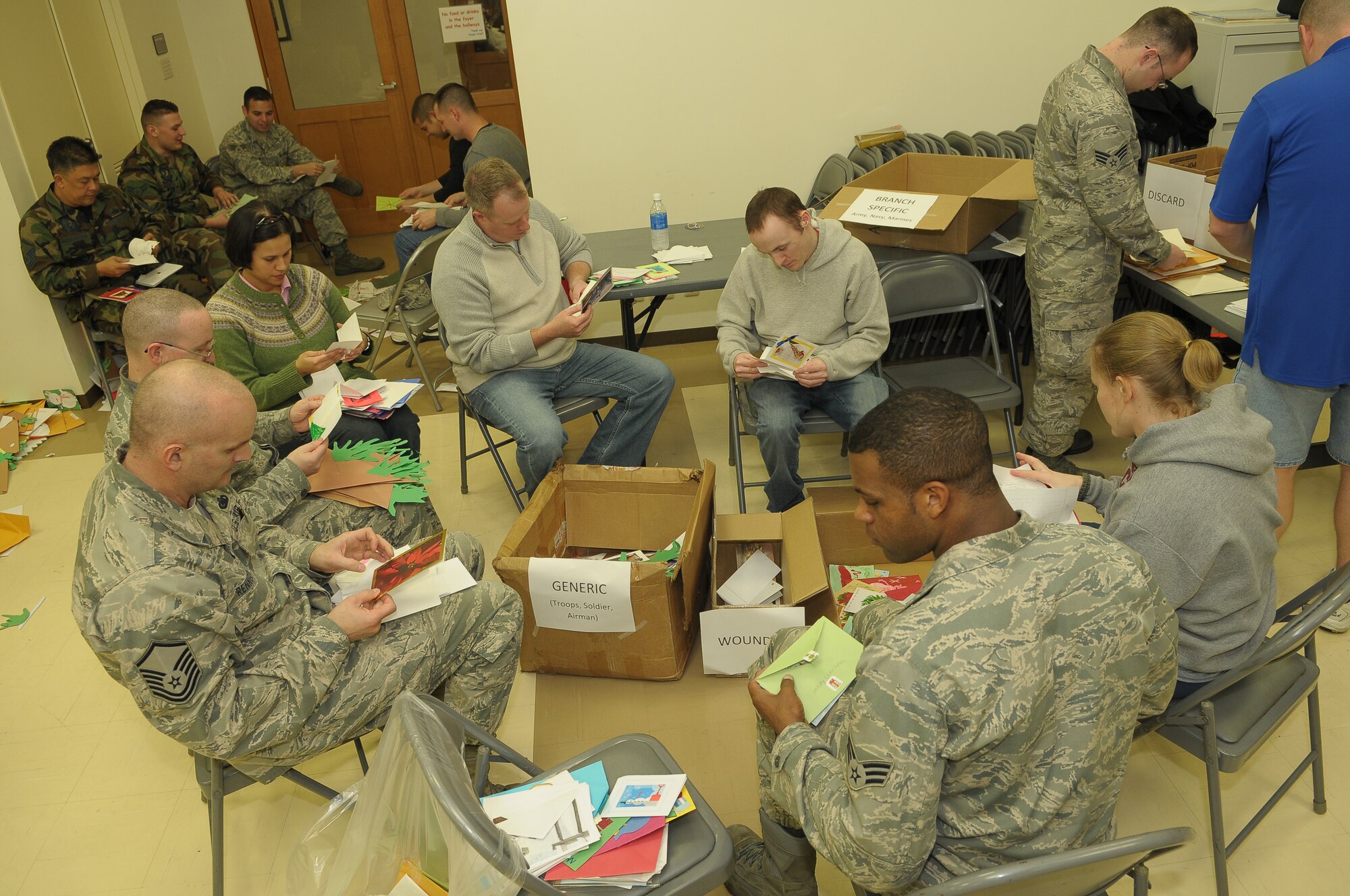 YOKOTA AIR BASE, Japan -- Volunteers sort and package more than 15,000 holiday cards Dec. 17 at the main chapel during the American Red Cross' "Holiday Mail for Heroes" campaign. (U.S. Air Force photo/Airman 1st Class Sean Martin)