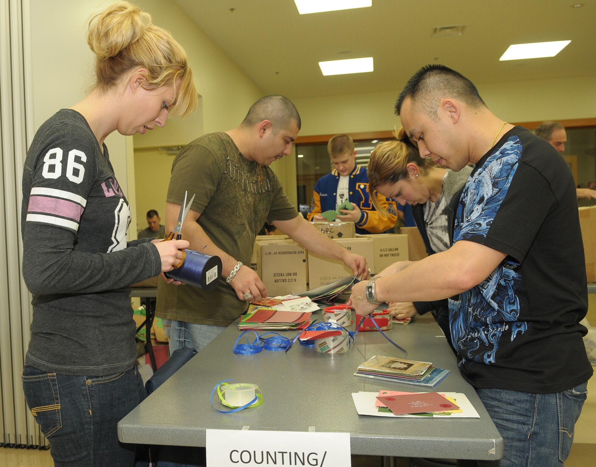 YOKOTA AIR BASE, Japan -- Volunteers sort and package more than 15,000 holiday cards Dec. 17 at the main chapel during the American Red Cross' "Holiday Mail for Heroes" campaign. (U.S. Air Force photo/Airman 1st Class Sean Martin)