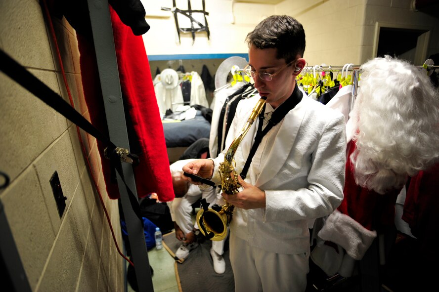 Tops in Blue performer Senior Airman Simon Lahn checks his saxophone beforegoing on stage to perform for a standing room only audience at Osan AirBase, Republic of Korea, Dec. 17.  (U.S. Air Force photo/Staff Sgt. BrianFerguson)