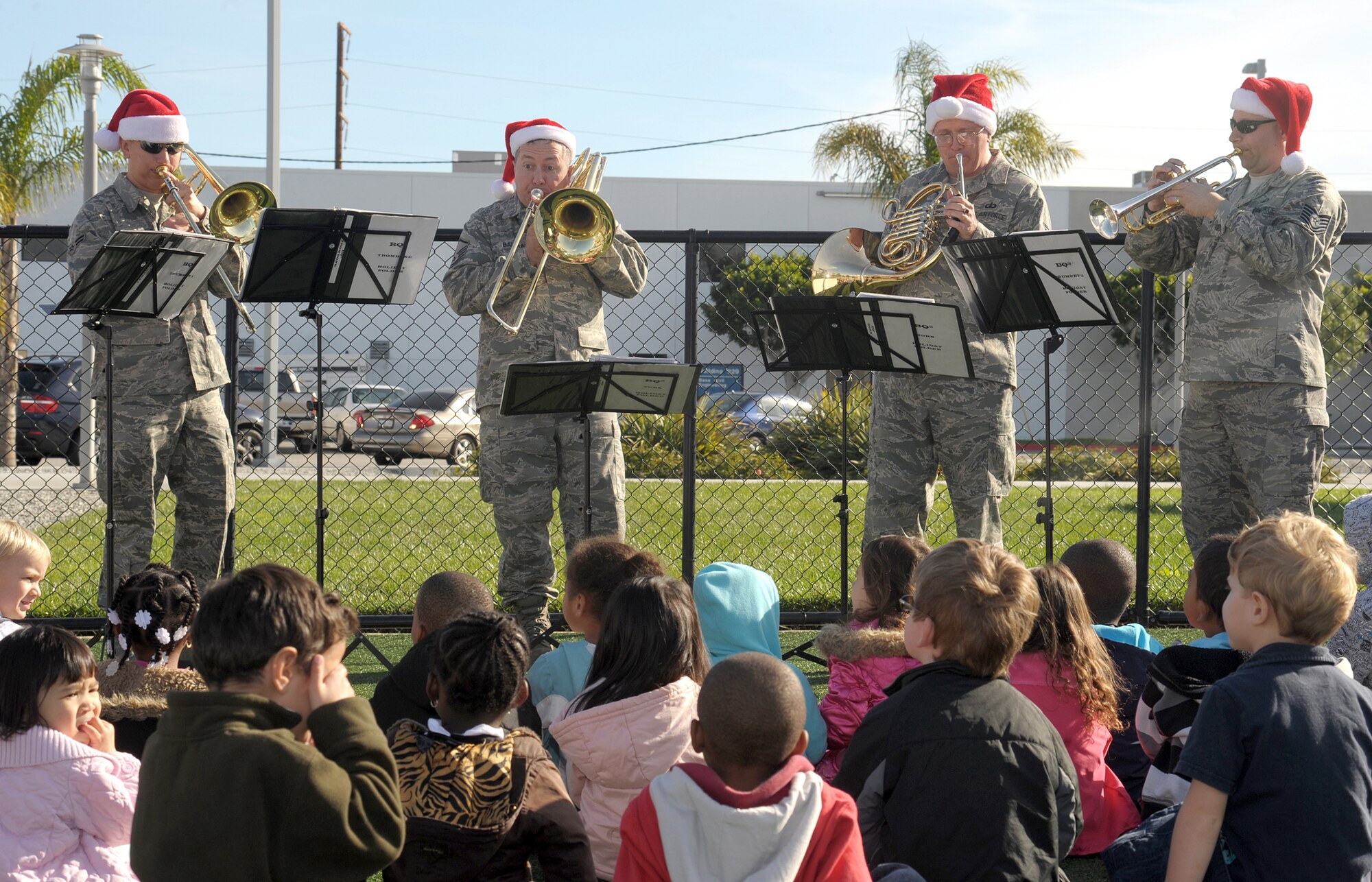 The United States Air Force Band of the Golden West’s brass band stationed at Travis Air Force Base, Calif., performs at the Child Development Center, during their visit to Los Angeles AFB, Dec. 16. The band played holiday music at multiple venues and work areas throughout the base to spread some holiday cheer. (Photo by Atiba S. Copeland)