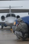 Senior Airman Edward Brant, 12th Security Forces Squadron first responder, radios in a situation report to his supervisor during a base-wide hijacking exercise.  Members of the 12th Flying Training Wing conducted a base-wide exercise, which tested the coordinated response of first responders, emergency support functions and others during a simulated hijacking of a T-1A Jayhawk aircraft and a terrorist attack.  (U.S. Air Force photo by Steve White) 