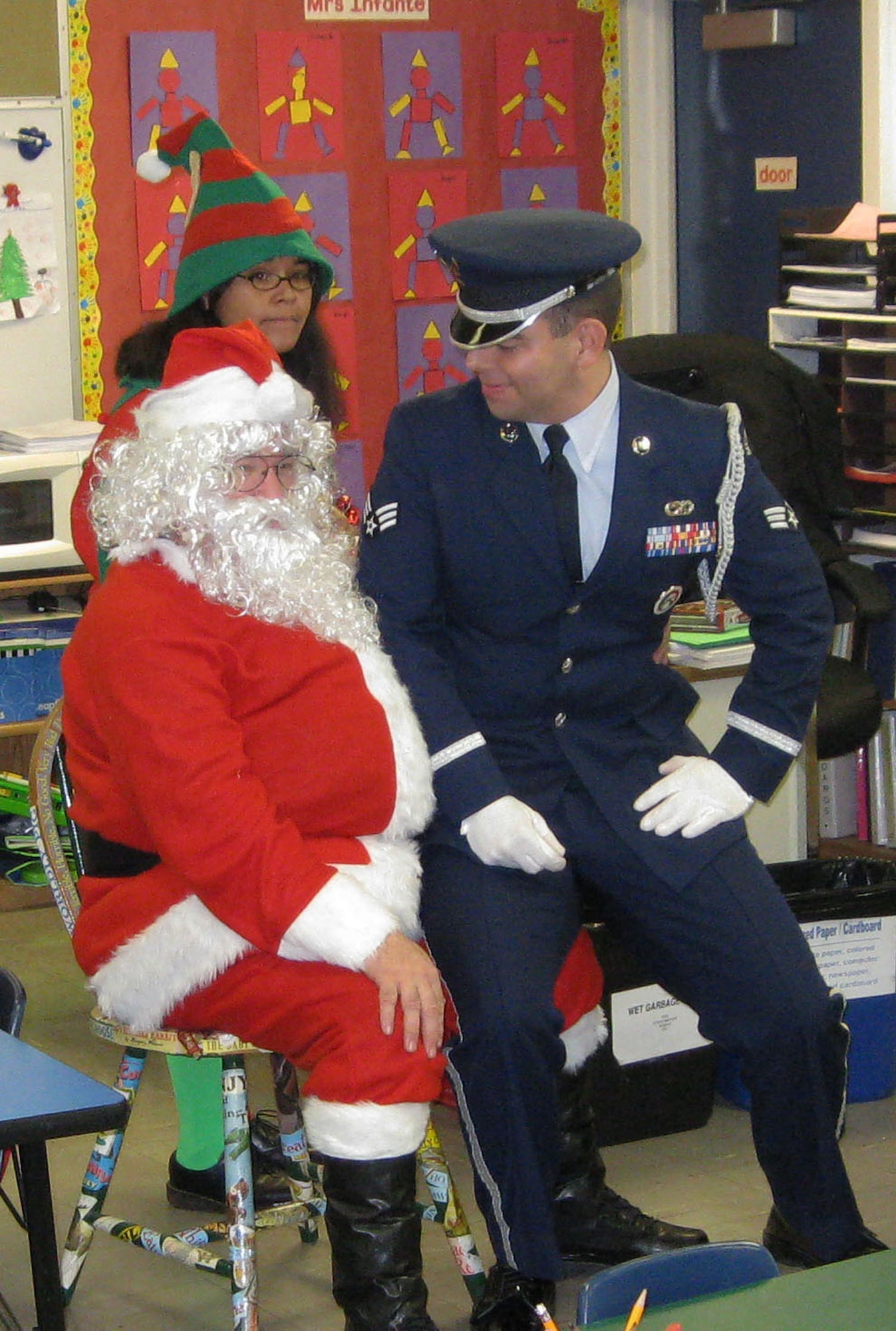 TRAVIS AIR FORCE BASE, Calif. -- Dan Allen, 349th Medical Squadron) listened to the wishes of the 349th Air Mobility Wing Honor Guard Dec. 14. Operation Teddy Bear has been giving back to the local communities for more than 25 years, with visits to disadvantaged kindergarten children in Title 1 schools. On a visit to Anna Kyle Elementary School in Fairfield, Calif., the reservists from the 349th AMW brought joy with gifts of teddy bears and goody bags full of small gifts. Sponsored by the wing Top Three Group, different squadrons each year share in the preparations and do the bulk of the work. This year, the 349th Medical Group was the lead unit, supported, as always, by the Honor Guard. (U.S. Air Force photo/Senior Master Sgt. Ellen L Hatfield).     