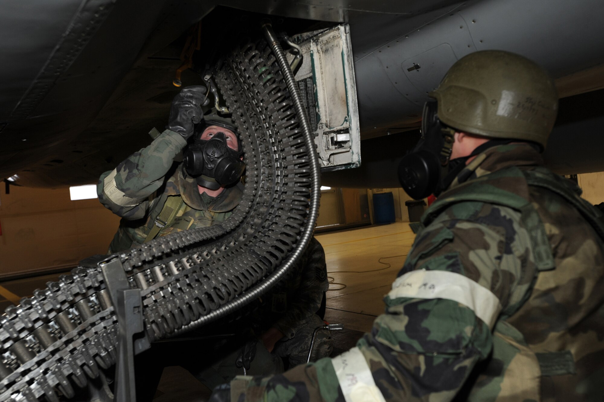 ELMENDORF AIR FORCE BASE, Alaska -- Airman 1st Class Daniel Tinnel, 19th Aircraft Maintenance Unit, connects the Universal Ammunition Loading System to an F-15 Dec. 11. The load crew competition was performed in Mission Oriented Protective Posture gear for the first time on Elmendorf AFB. (U.S. Air Force photo/Airman 1st Class Kristin High)