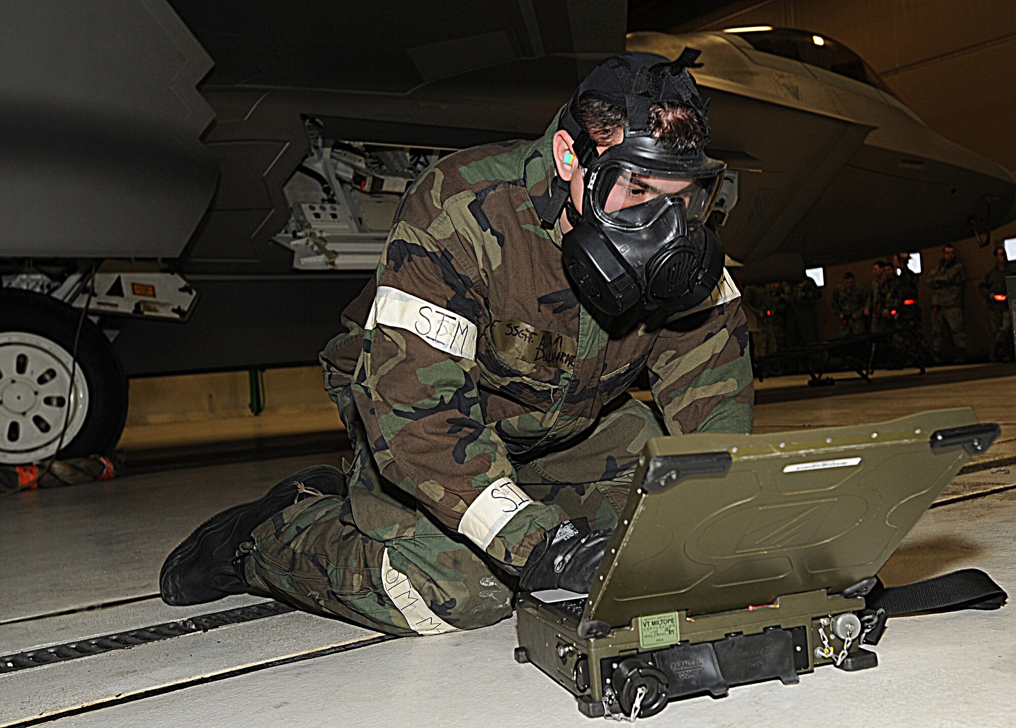 ELMENDORF AIR FORCE BASE, Alaska -- Staff Sgt. Adam Ducharme, 90th Aircraft Maintenance Unit, uses portable maintenance aid to follow technical data on the F-22 Raptor Dec.11. The load crew competition was performed in Mission Oriented Protective Posture gear for the first time on Elmendorf AFB. (U.S. Air Force photo/Airman 1st Class Kristin High)