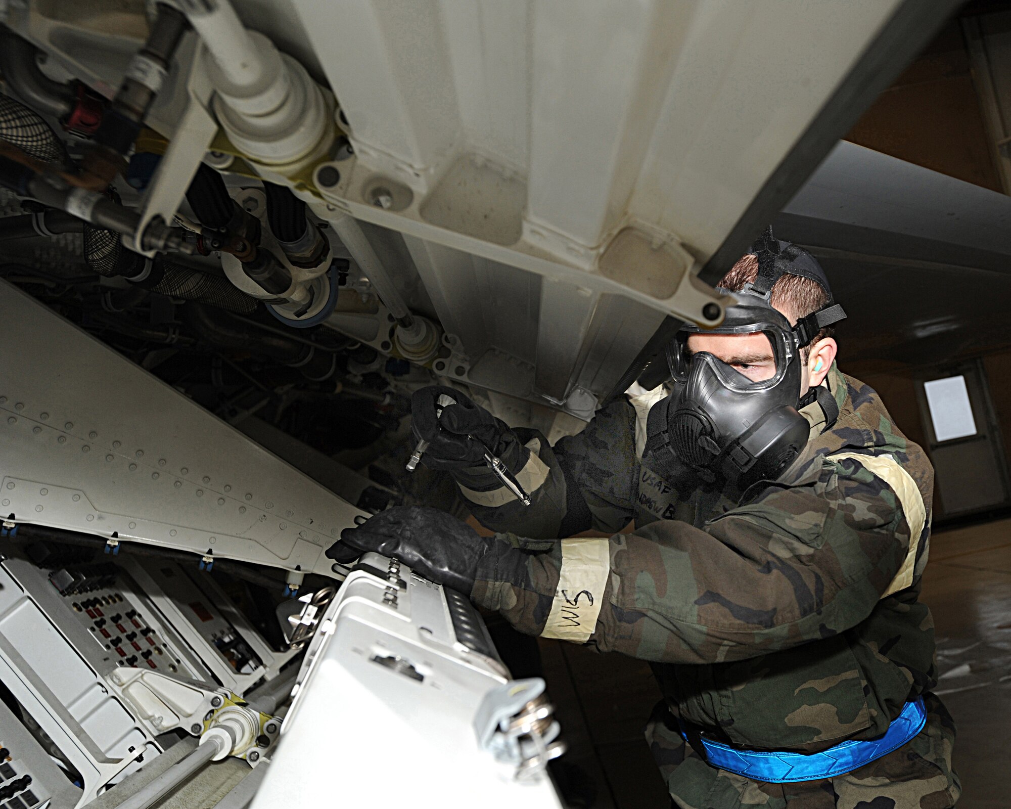 ELMENDORF AIR FORCE BASE, Alaska -- Senior Airman Andrew Borger, 525th Aircraft Maintenance Unit, prepares the LAU-141 Missile Launcher for the missile to be installed on an F-22 Raptor Dec.11. The load crew competition was performed in Mission Oriented Protective Posture gear for the first time on Elmendorf AFB. (U.S. Air Force photo/Airman 1st Class Kristin High)