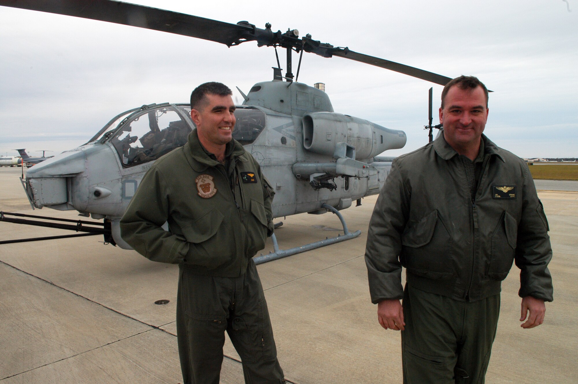 Lt. Col Steve Godinho and Lt. Col Joe Crane exit the AH-1W Cobra they flew into Robins to check out landing locations on the flightline and to refuel. U. S. Air Force photo by Sue Sapp  