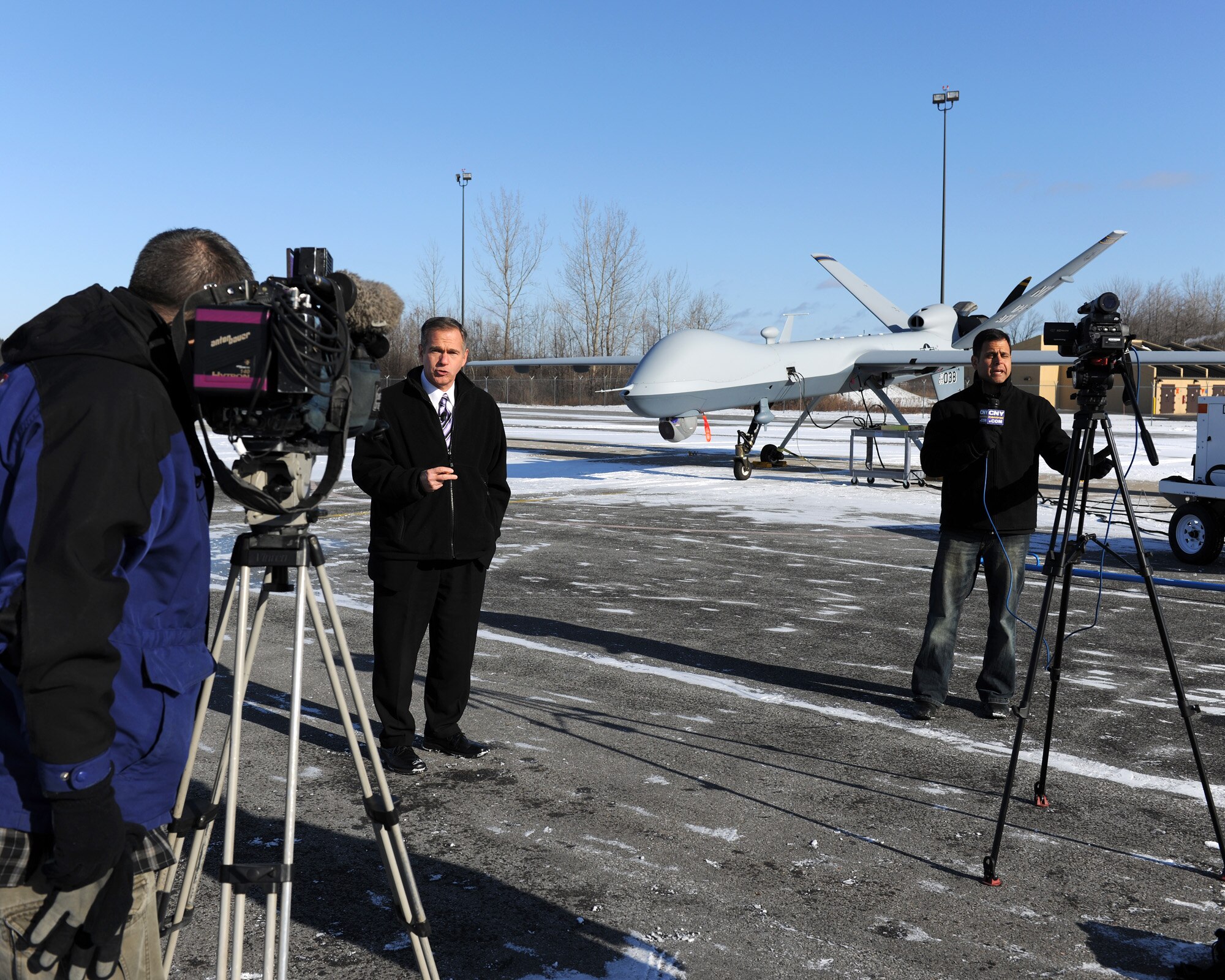 Members of the local media record stand-ups in front of an MQ-9 Reaper Remotely Piloted Aircraft at Hancock Field in Syracuse, NY on 17 Dec. 2009. The media were invited to observe MQ-9 operations at the 174th Fighter Wing. (US Air Force photo by Tech. Sgt. Jeremy M. Call/Released)