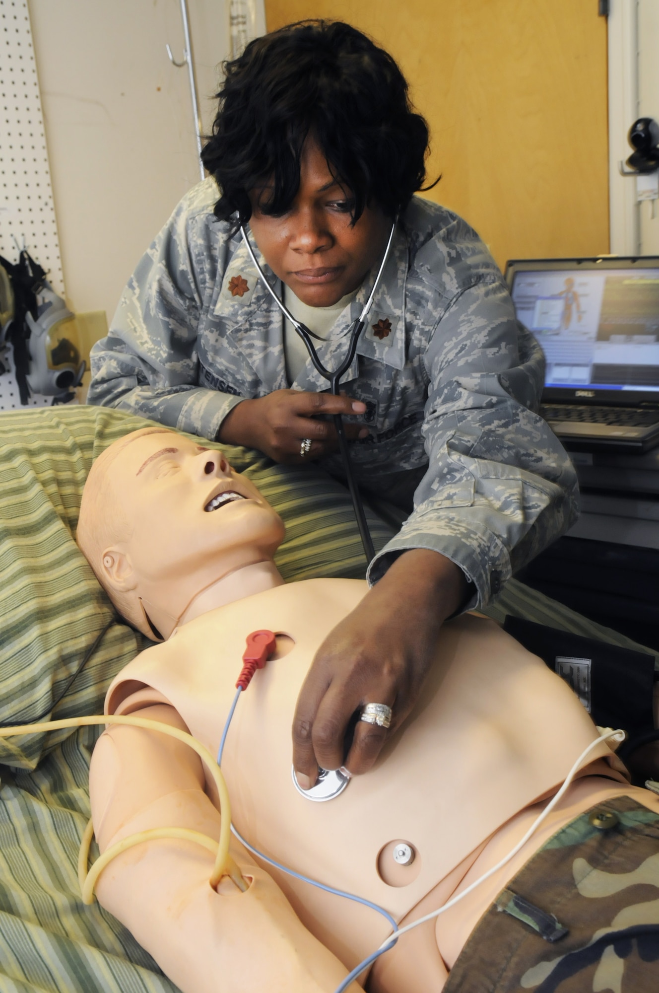 Maj. Phaedra Christenson demonstrates how the Simman can be programmed to simulate realistic symptoms as a training tool. U. S. Air Force photo by Sue Sapp