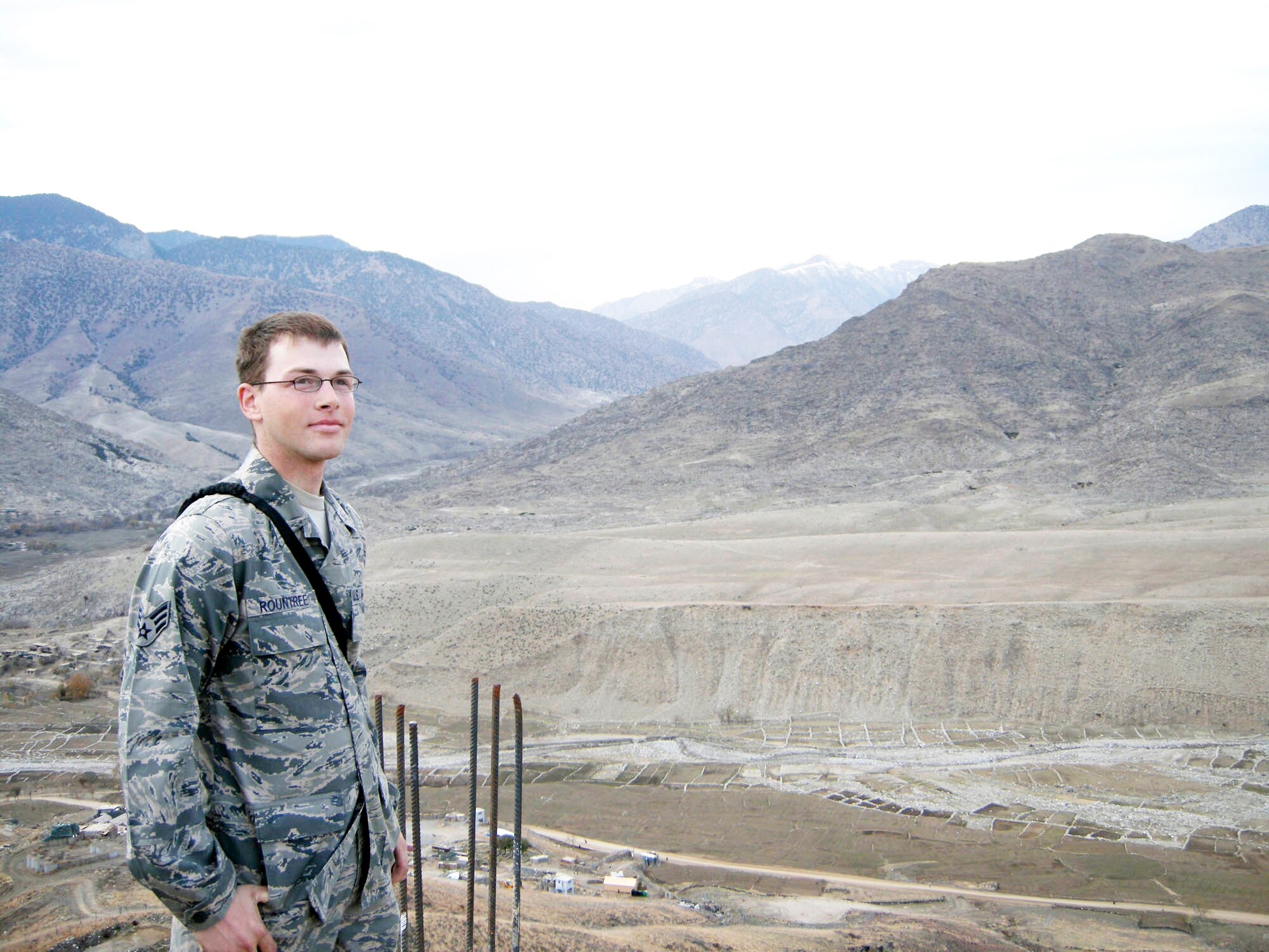 Senior Airman Randell Rountree takes a break to get a good view of the mountains at his remote location in Eastern Afghanistan. Airman Rountree is deployed from the 1st Communication Squadron at Langley Air Force Base, Va., is the one Airman that Soldiers at their combat outpost depend upon for all of their Internet and telephone communications. (U.S. Air Force photo/Master Sgt. Todd Triplett)