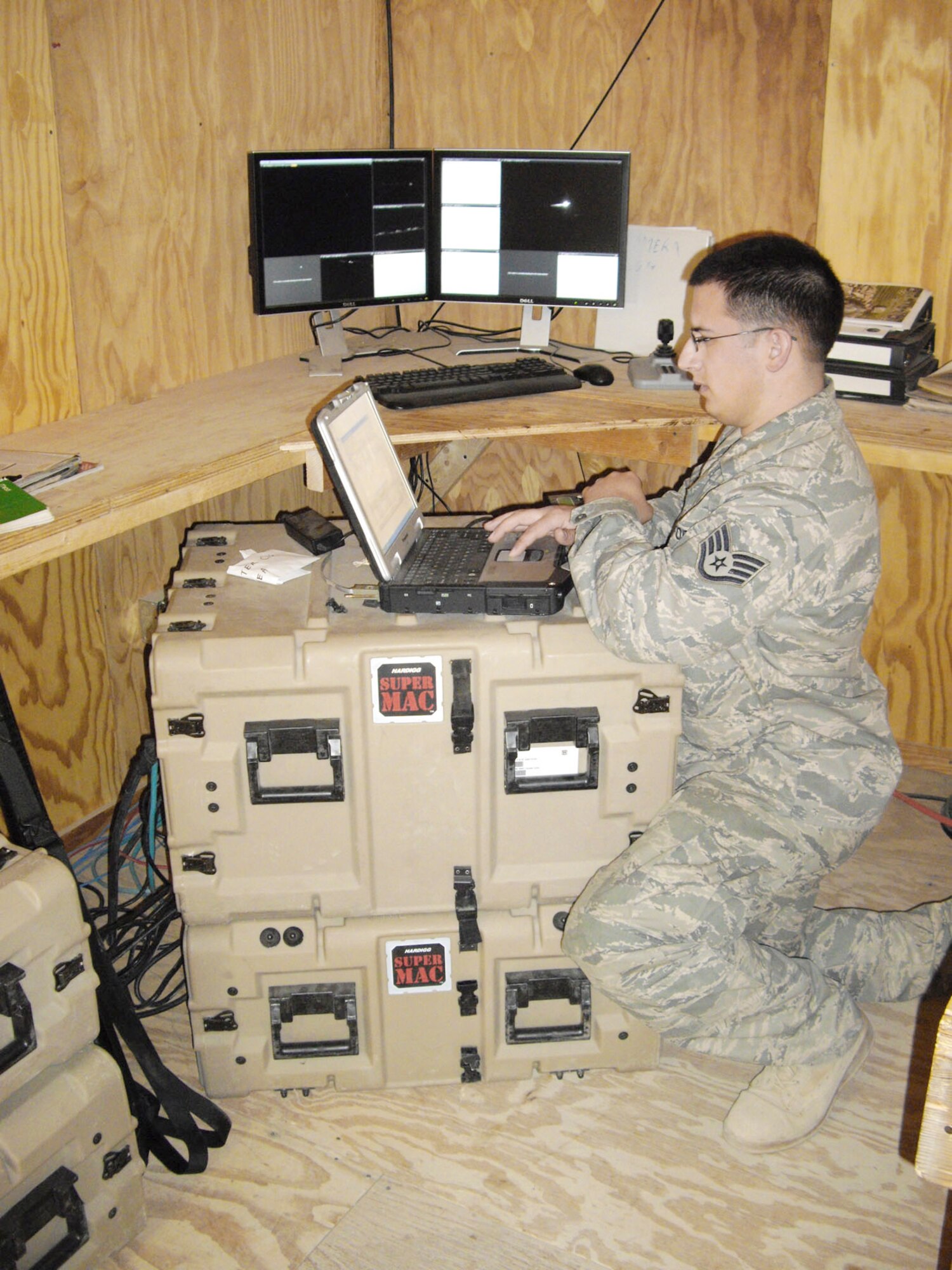 Staff Sgt. Shaun DeCroo works on a ruggedized laptop to help set up critical internet communications for Soldiers. Sergeant DeCroo is a deployed from the 50th Communications Squadron at Scheiver Air Force Base, Colo., and serves at an Army combat outpost in a remote section of Afghanistan. (U.S. Air Force photo/Master Sgt. Todd Triplett)