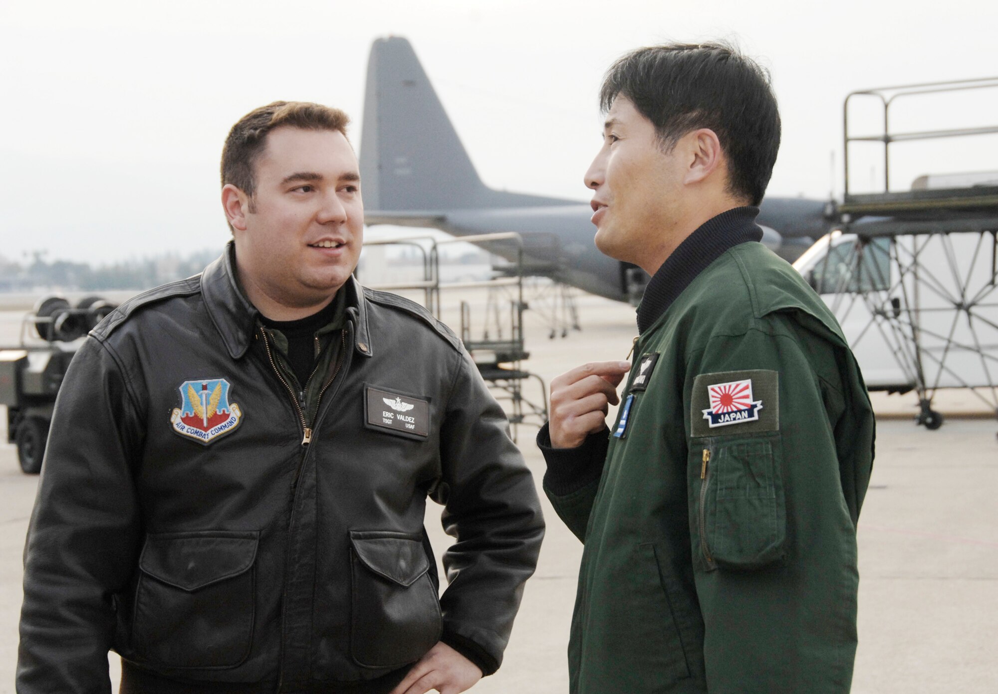 Maj. Masahiko Miyazaki speaks with Tech. Sgt. Eric Valdez about their air refueling training Dec. 9, 2009, at Moffett Federal Airfield, Calif.  Major Miyazaki is a Japan Air Self-Defense Force C-130H Hercules pilot with the 1st Tactical Airlift Wing at Komaki Air Base, Japan. Sergeant Valdez is an aircraft loadmaster with the 130th Rescue Squadron at Moffett Field. (U.S. Air Force photo/Tech. Sgt. Ray Aquino) 