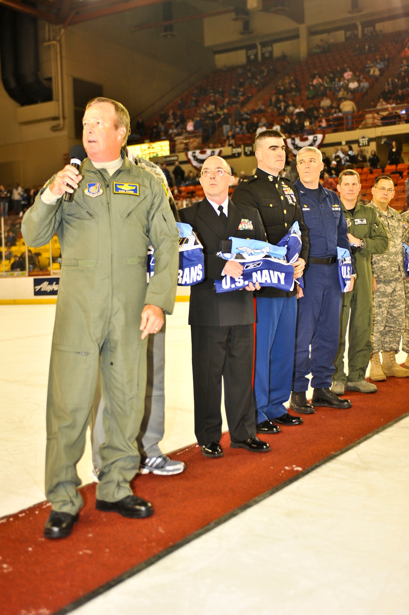 ANCHORAGE, Alaska – Lt. Gen. Dana Atkins, Alaskan Command/11th Air Force commander, talks to the crowd after handing out personalized Alaska Aces jerseys to several members of different military branches, during the first intermission of an Alaska Aces game Dec. 12. The Alaska Aces organization held a three-game military appreciation series Dec. 11-13. (U.S. Air Force photo/Airman 1st Class Christopher Gross)