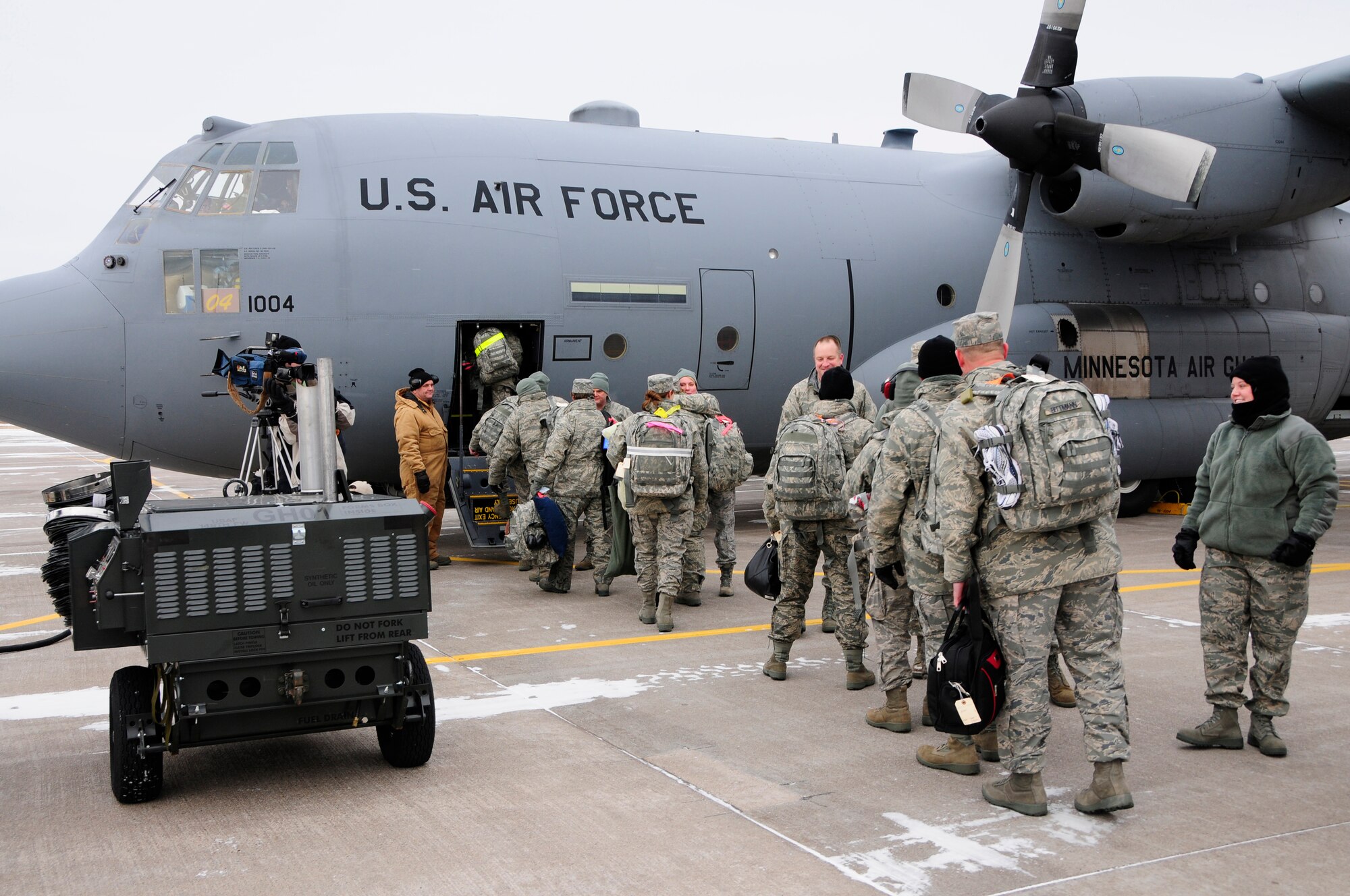 Members of the 148th Fighter Wing Air National Guard load a C-130 Hercules as part of the first wave of Civil Engineers from the wing to depart Duluth, Minn. Dec. 17th, 2009.  A large number of 148th Civil Engineers will deploy to Bagram Airfield, Afghanistan for approximately six months in late 2009 and early 2010.