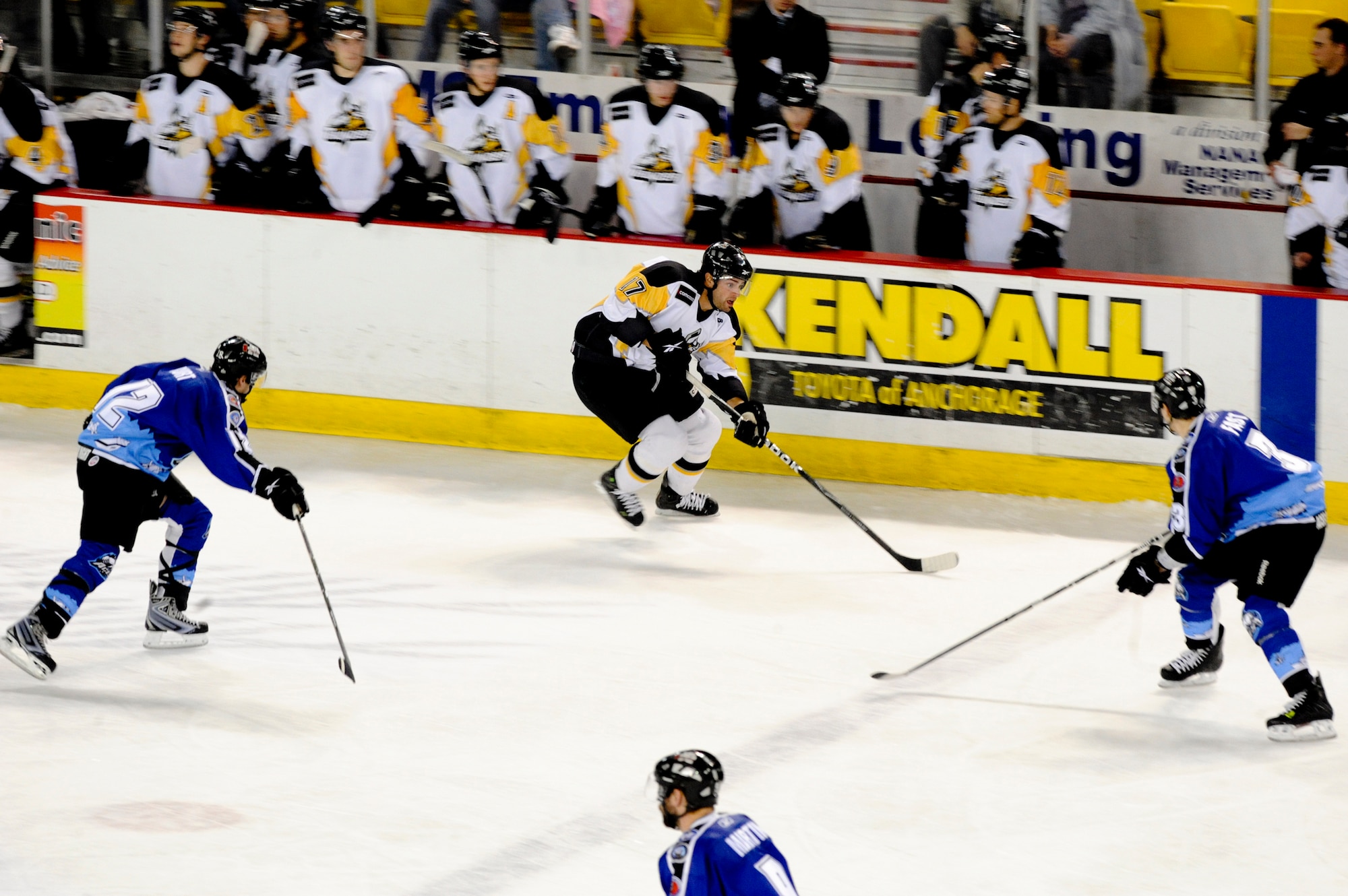 ANCHORAGE -- Jason Pittman, left wing for the Stockton Thunder, attempts to skate past members of the Alaska Aces during the Military Appreciation game at Sullivan Arena, Dec. 11, 2009. (U.S. Air Force Photo by Staff Sgt. Joshua Garcia)