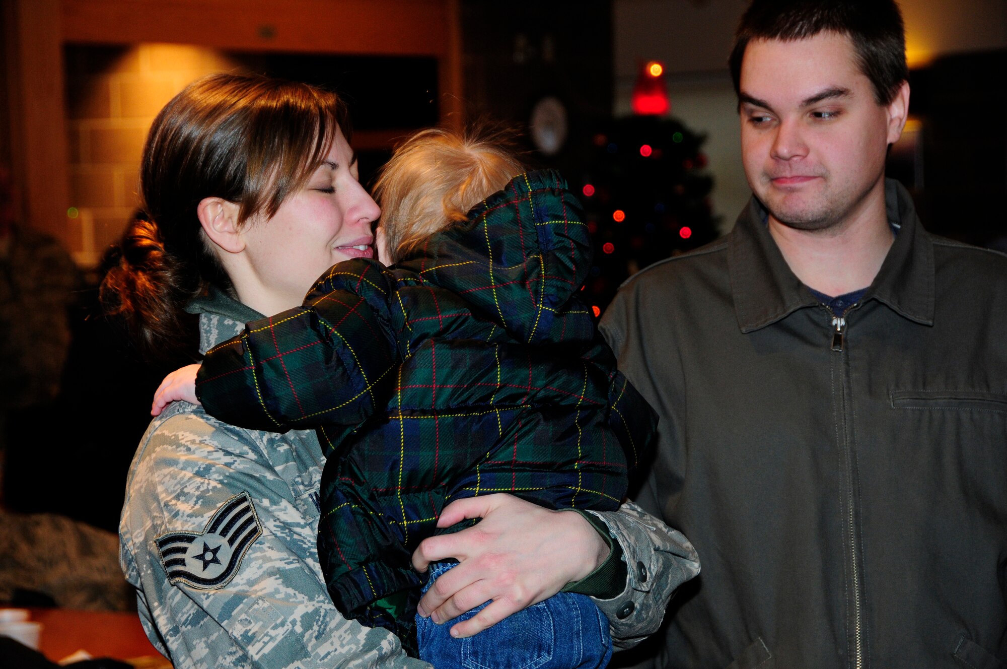U.S. Air Force Staff Sgt. Christa Wood hugs her son goodbye as the first wave of Civil Engineers from the 148th Fighter Wing departs Duluth, Minn.  Dec. 17th, 2009.  A large number of 148th Civil Engineers will deploy to Bagram Airfield, Afghanistan for approximately six months in late 2009 and early 2010.