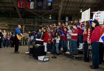 HANSCOM AIR FORCE BASE, Mass. -- Hanscom Middle School music teacher Howard Worona (left), accompanies the middle school choir during a performance at Hanscom's Heroes' Homecoming celebration Dec. 11. The event honored nearly 30 servicemembers who have returned from deployments within the last six months.  (U.S. Air Force photo by Mark Herlihy)