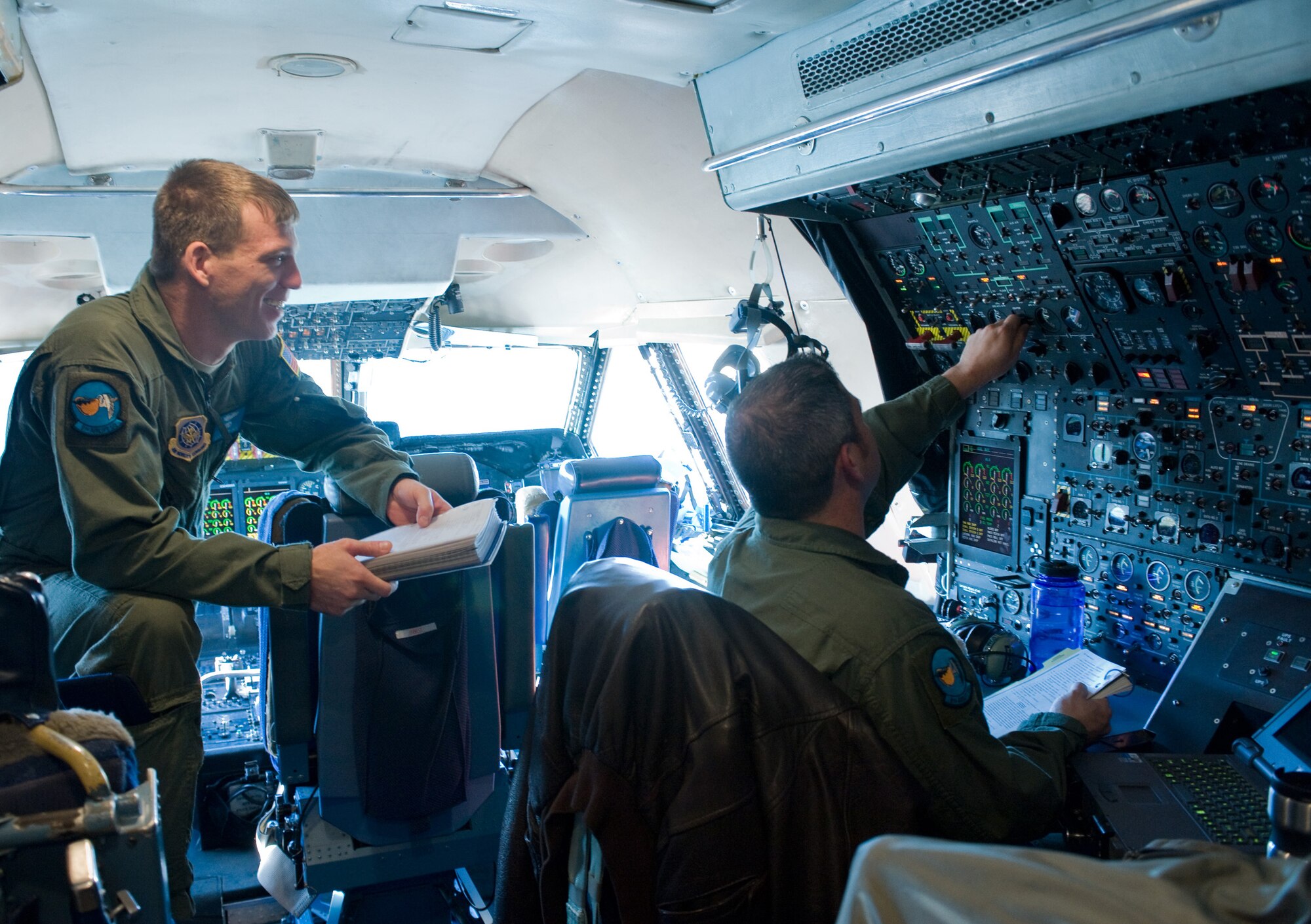 Members of the 9th Airlift Squadron review instrument panels during training Dec. 1. The 9th AS flight engineers require constant training on the aircraft's systems for proper upkeep. (U.S. Air Force photo/Brianne Zimny) 