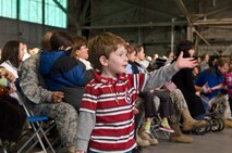 HANSCOM AIR FORCE BASE, Mass. - Simon Aidan watches as Airmen are congratulated for their deployed service Dec. 11 at the Hanscom Aero Club. Hanscom hosted a Heroes Homecoming event where the base and local community welcomed nearly 30 Airmen back from their deployments. The event hosted guests from the Hanscom, local and Boston communities, including Air Force Materiel Command and Hanscom senior leadership, New England Patriots hall of famer John Hannah and other distinguished guests. (U.S. Air Force Photo by Mark Herlihy)