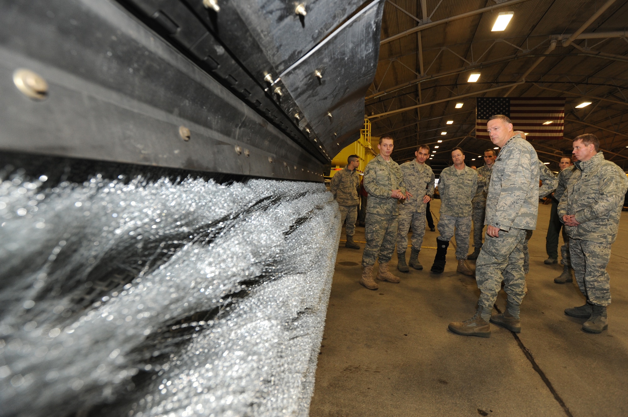 ELMENDORF AIR FORCE BASE -- Pacific Air Forces Commander Gen. Gary North receives a briefing on machines used for snow removal by a member of the 3rd Civil Engineer Squadron while visiting different squadrons of Elmendorf Air Force Base, Alaska, Dec. 8, 2009. General North visited the base as part of his tour of PACAF bases. (U.S. Air Force photo/ Staff Sgt. Joshua Garcia) 
